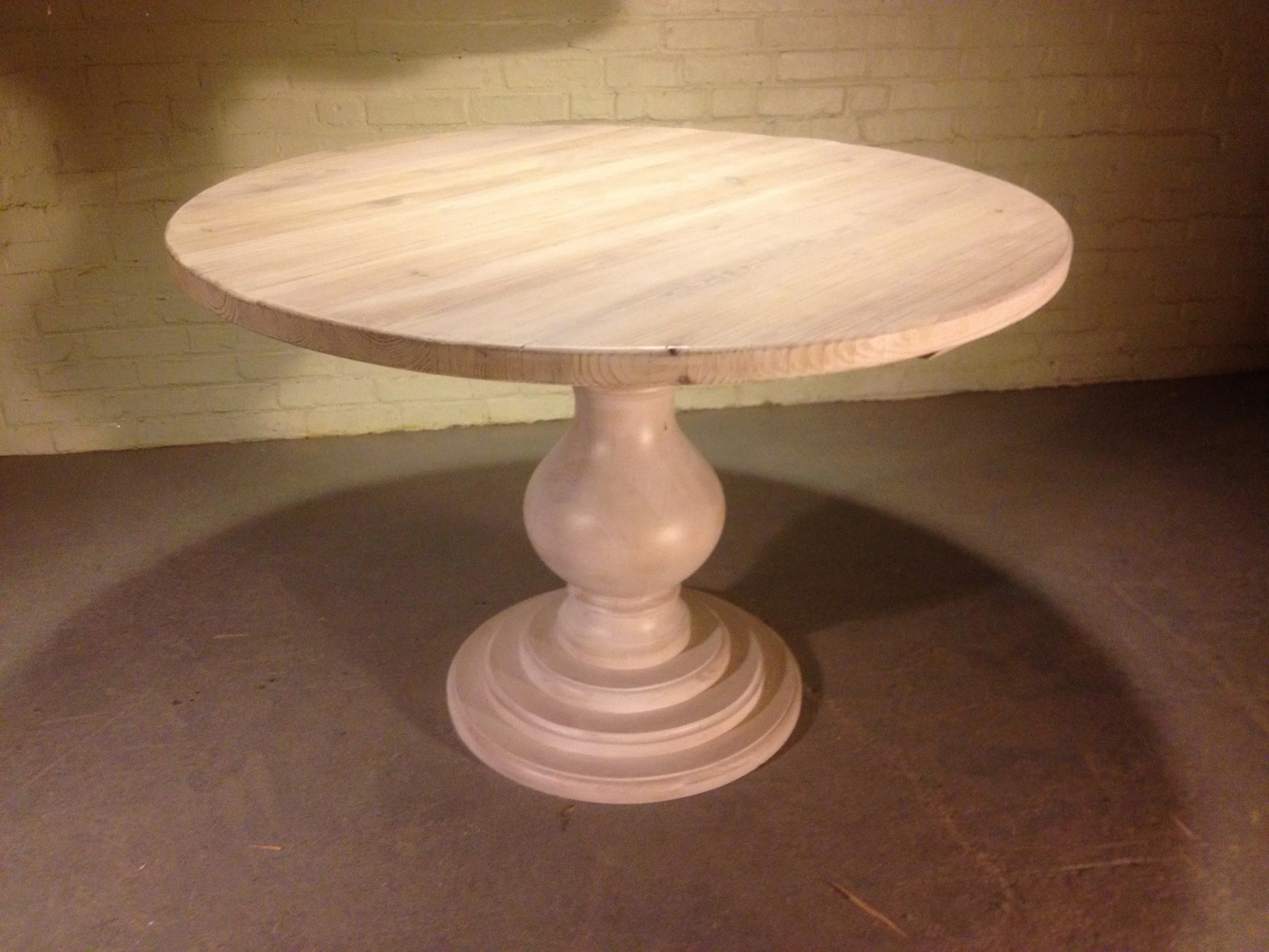 48" thick top round table with tiered Grand Classic base finished in White Wash