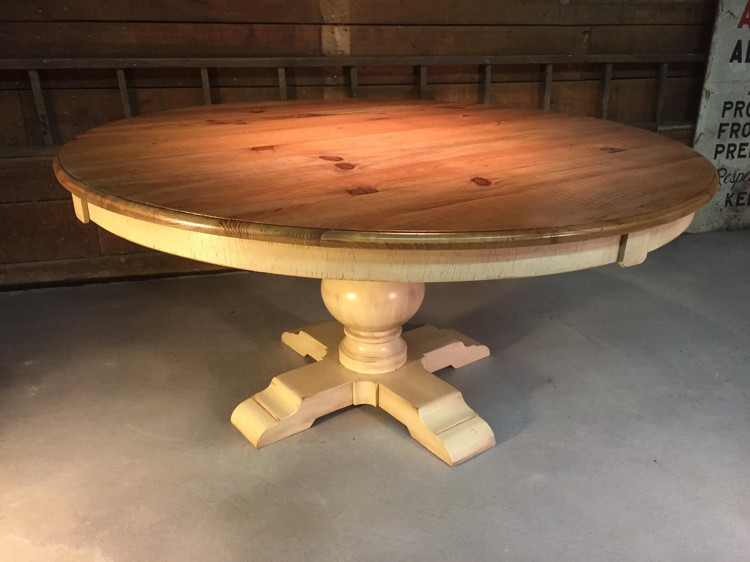 60" round thin top dining table with custom curved apron and Grand Classic pedestal finished in Golden Brown with glazed Ivory base