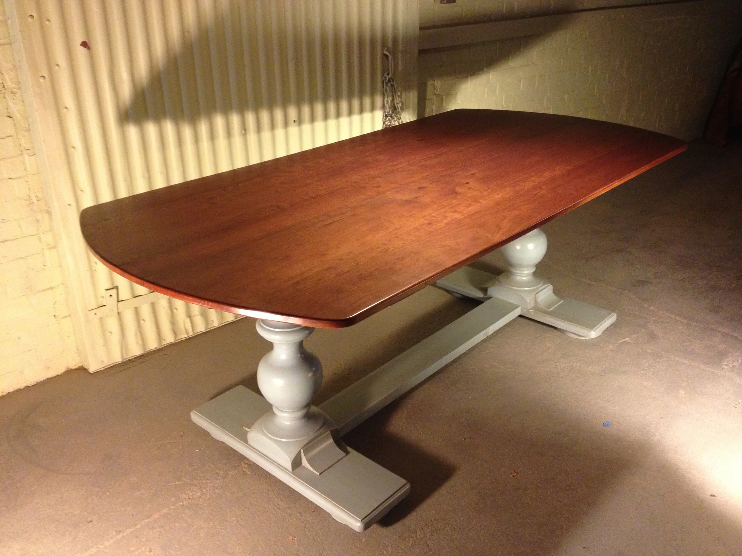 96"x38" Custom reclaimed cherry top with radius ends and a double Hosmer pedestal base finished in Deep Sky