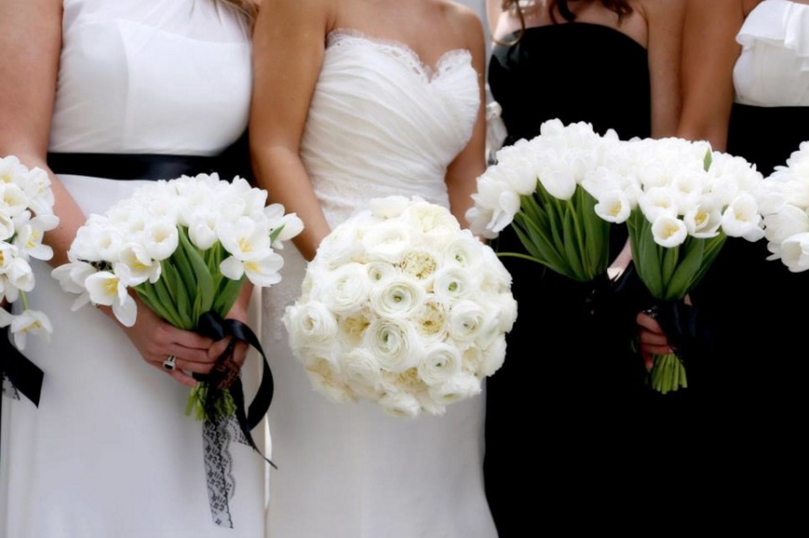 bride and bridesmaids with black and white floral bouquets