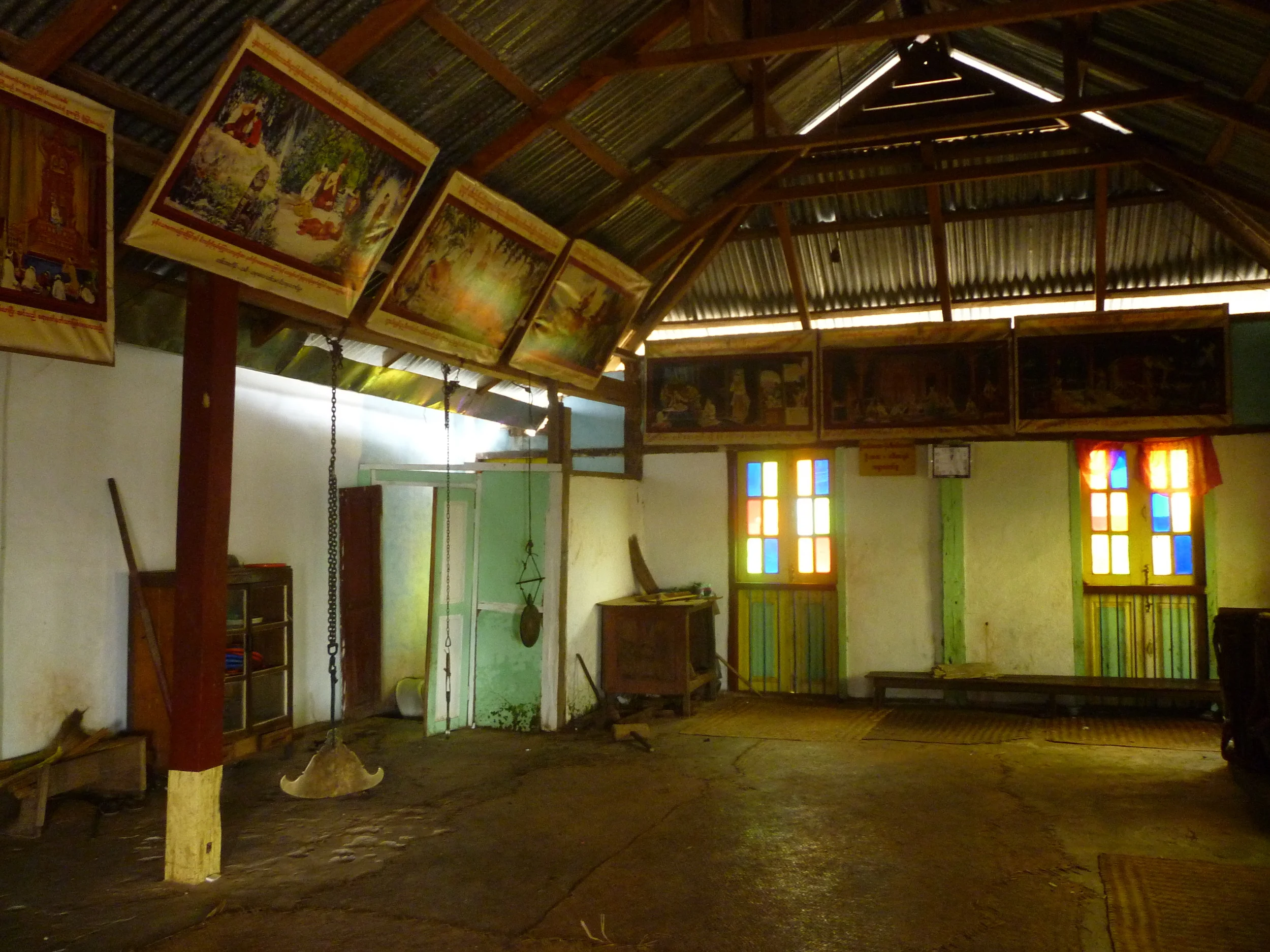 A Kyeezee hanging from a chain in a wooden monastery in a small village in Burma.