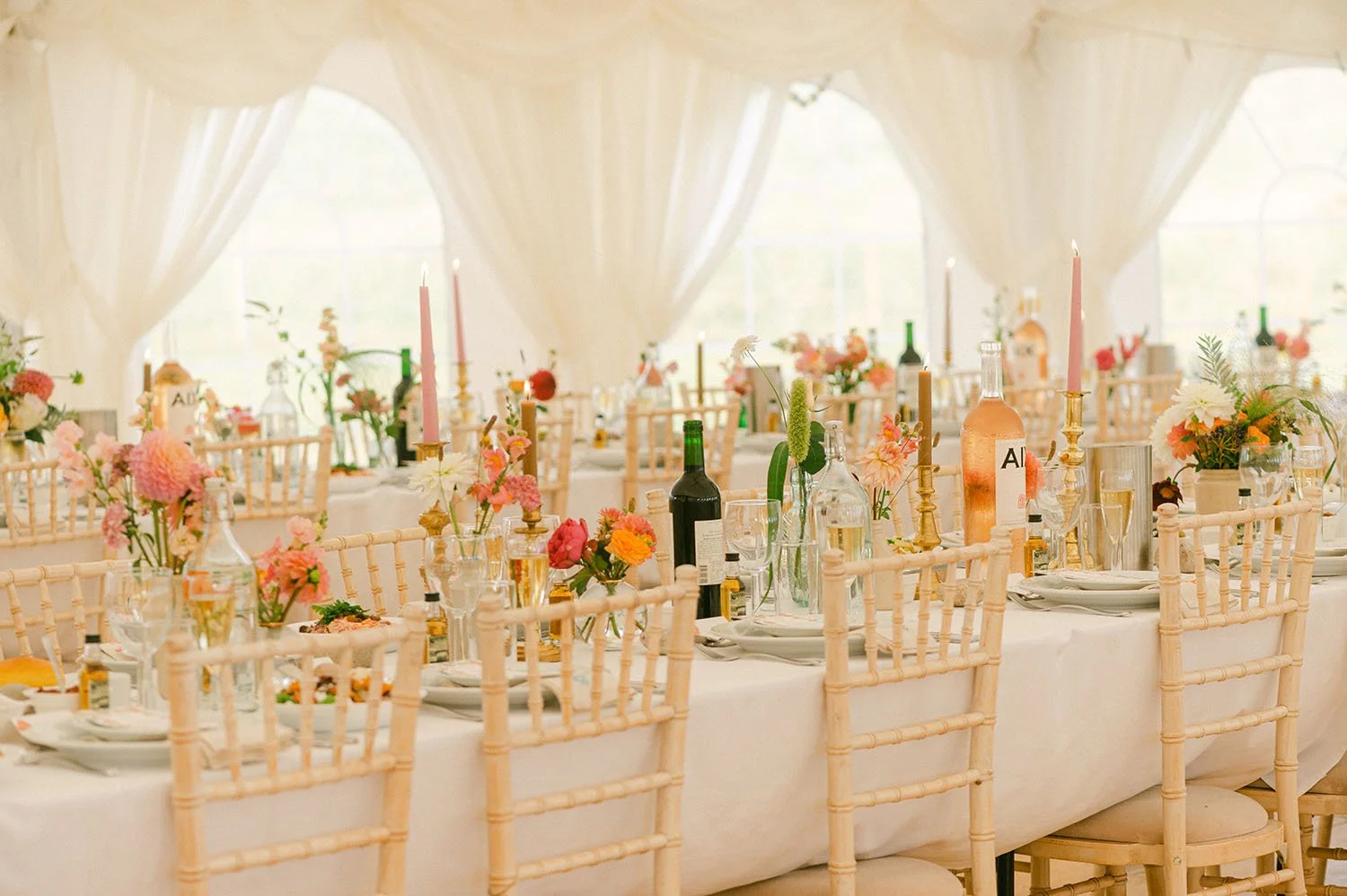 Tables laid out with beautiful flowers and decorations in a wedding marquee near Edinburgh, Scotland