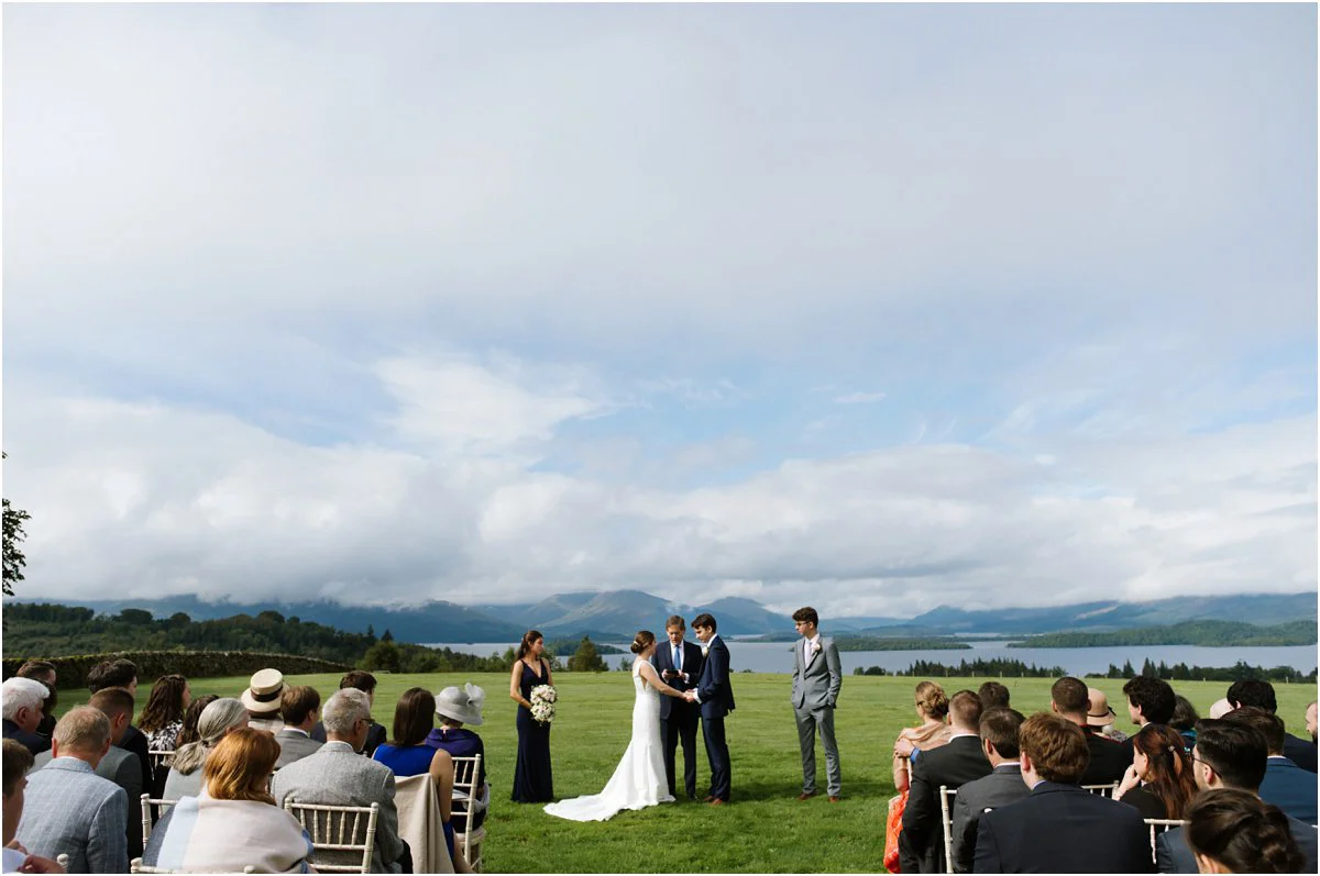 Couple saying wedding vows at a wedding ceremony overviewing Loch Lomond landscape