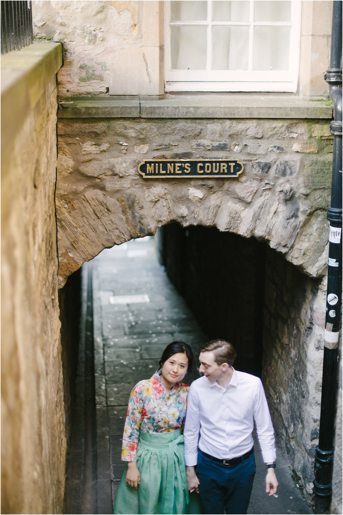  Korean Bride and British groom standing in Edinburgh Old Town Close 