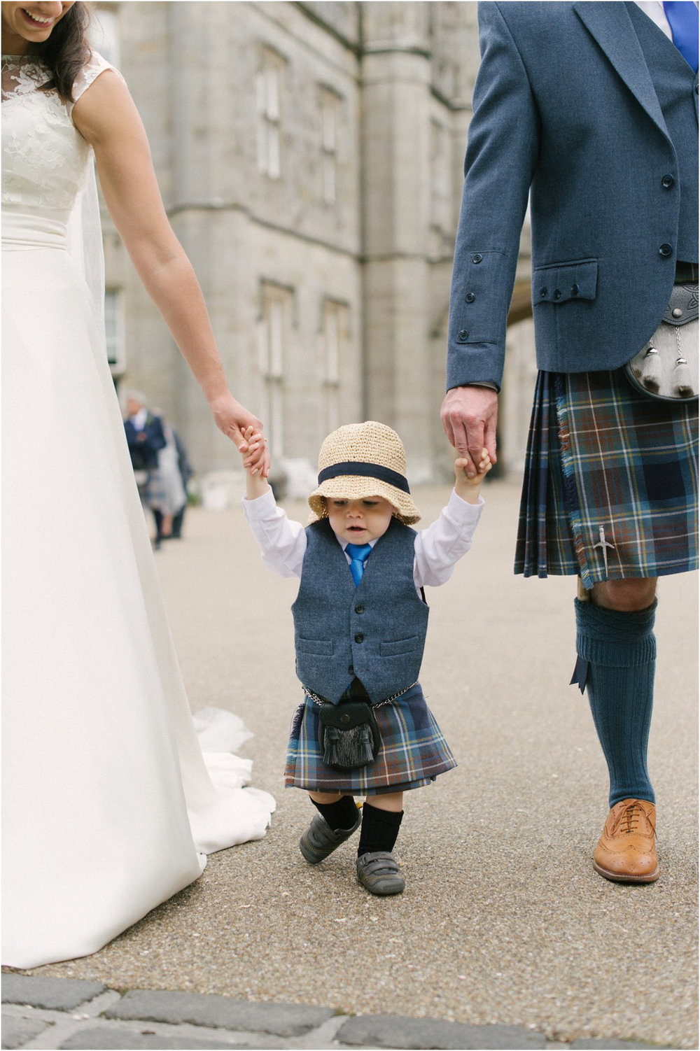  Newlyweds with their young child during their wedding in Blairquhan by Cro & Kow 