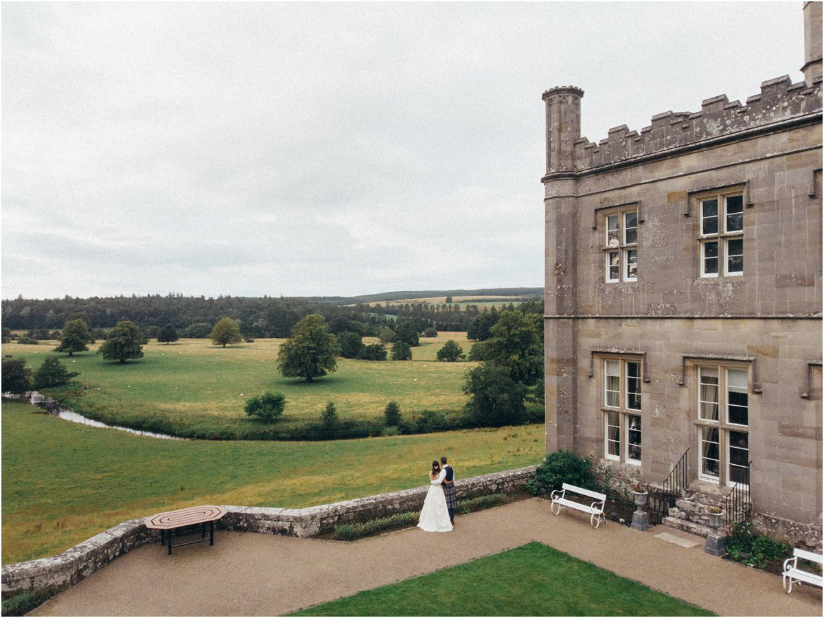  Bride and groom admiring landscape in front of a Scottish castle in Blairquhan by Cro & Kow 