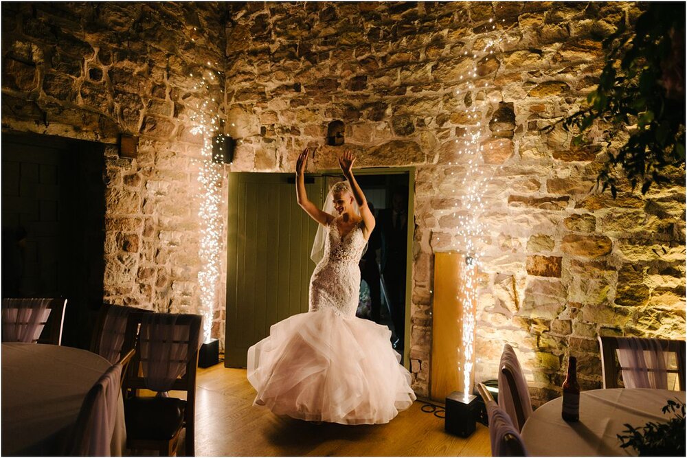  Bride entering her wedding party at The Ashes Barns in Endon 