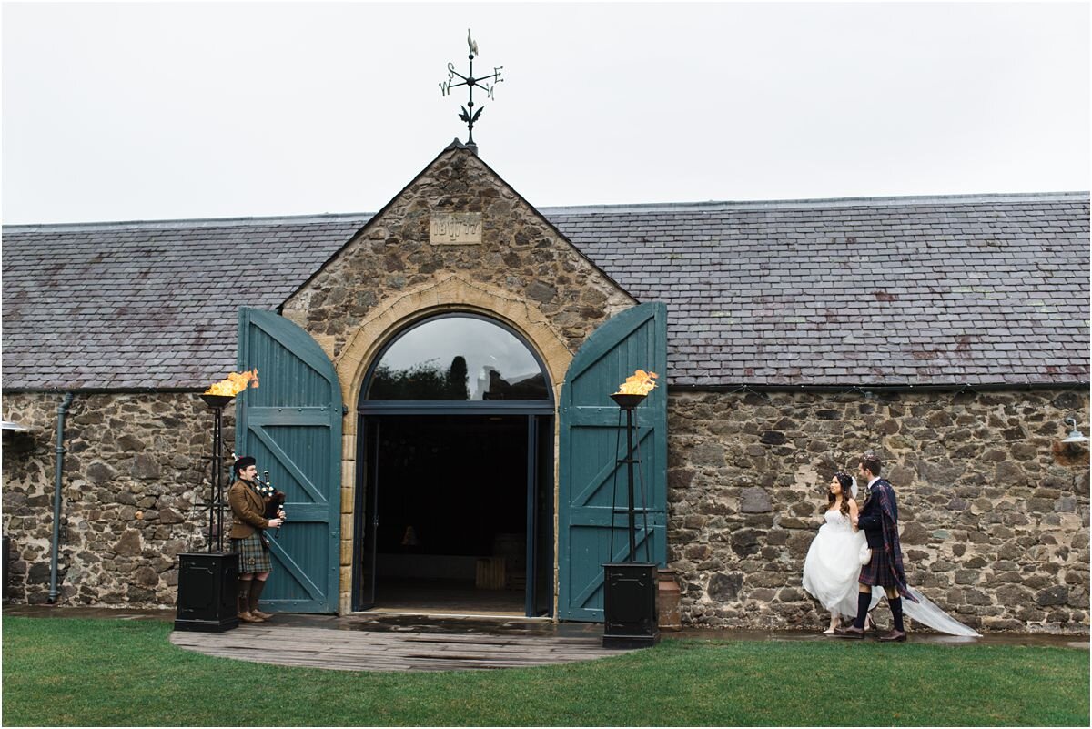  A wedding couple and a piper at The Byre At Inchyra in Scotland by Crofts & Kowalczyk Photography 