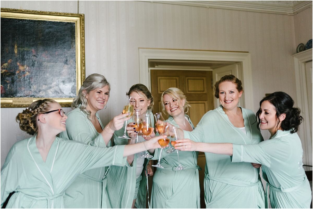  Bridesmaids toasting at the preparations for a Summer wedding at Winton castle Scotland  