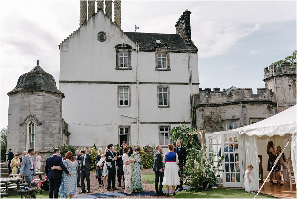  Winton castle Scotland with a marquee set up on a croquet lawn with a rustic flowers decoration 