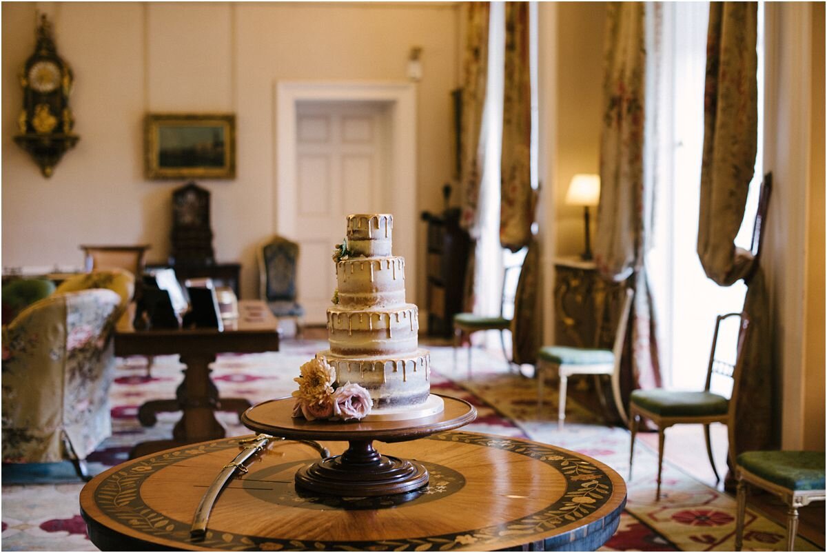  A spectacular multi tiered wedding cake at a Summer wedding inside the interior of  Winton castle Scotland  