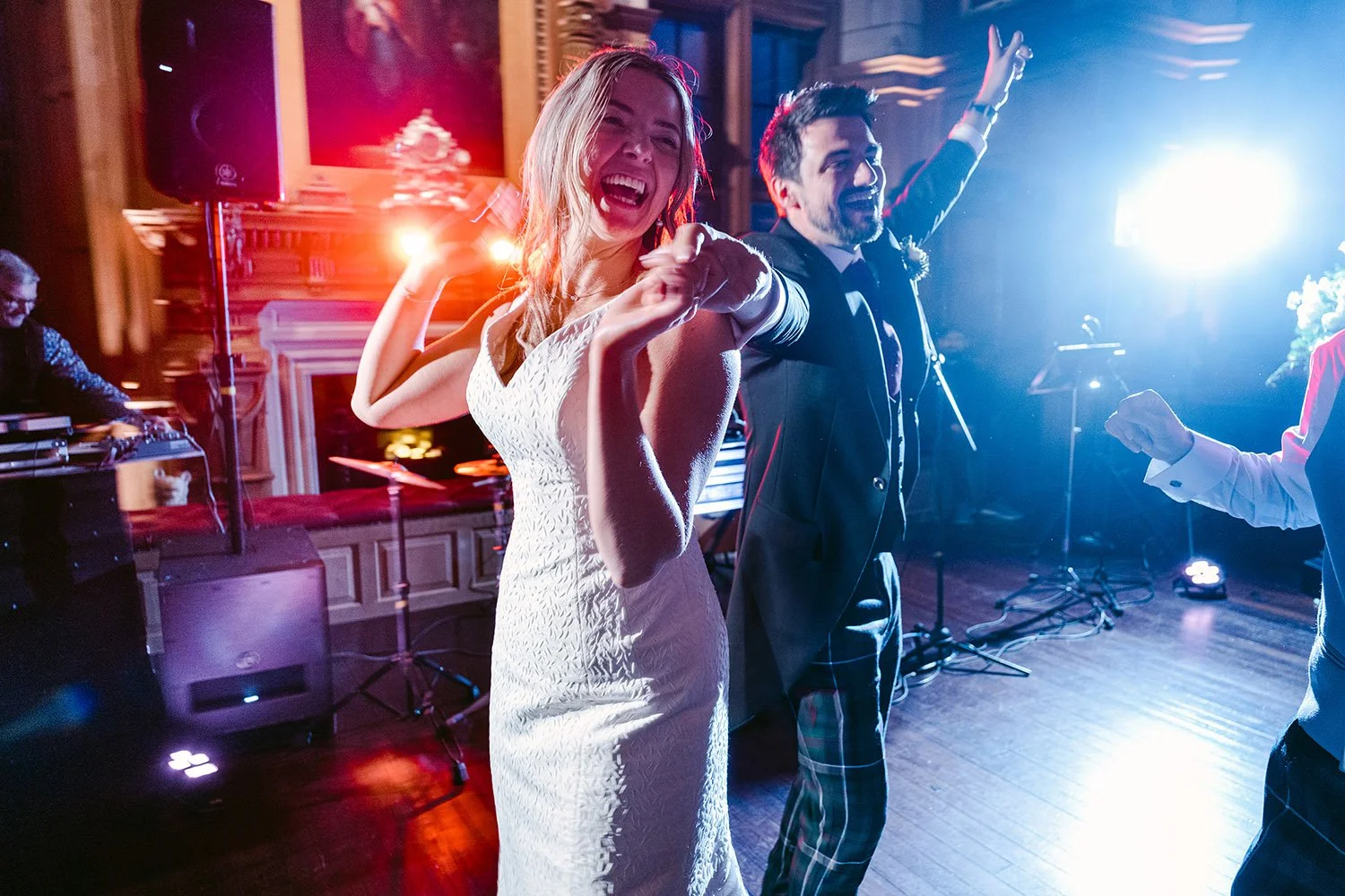 A bride and groom laughing during their first dance at Barnbougle Castle, Edinburgh, Scotland