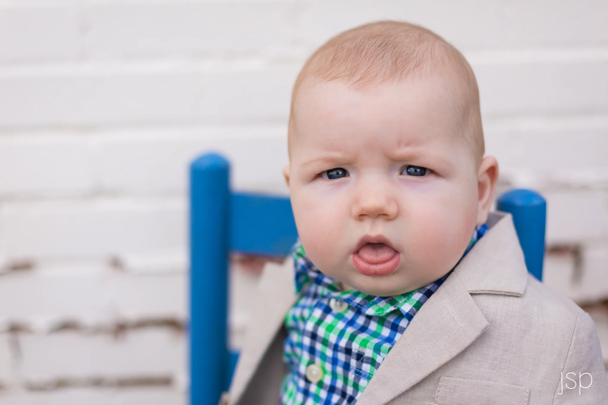 boy in bue chair white wall.jpg