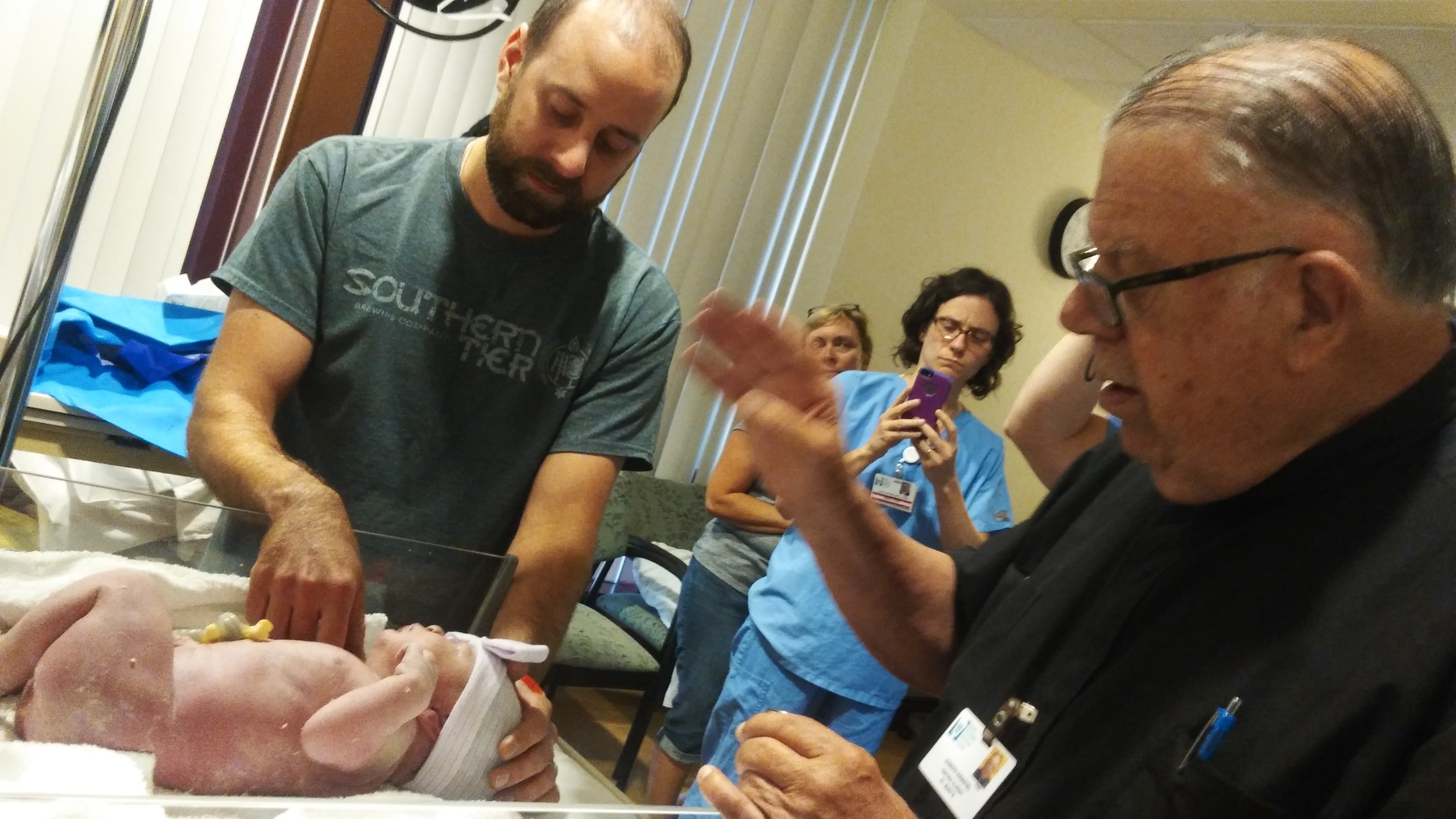 the catholic priest baptizes charlotte while wes is present.