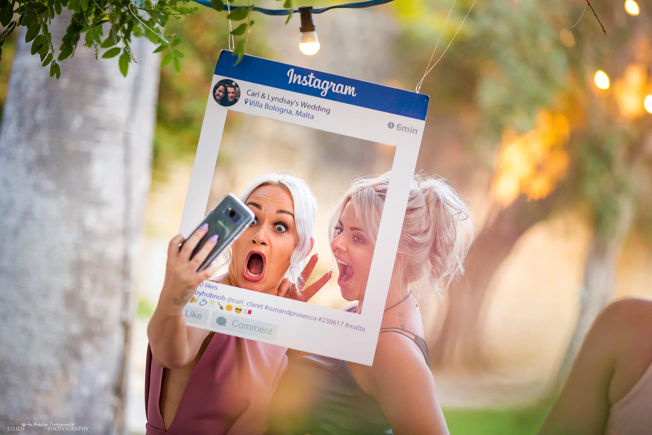 Wedding guests taking selfies. Photo by Elliot Nichol Photography.