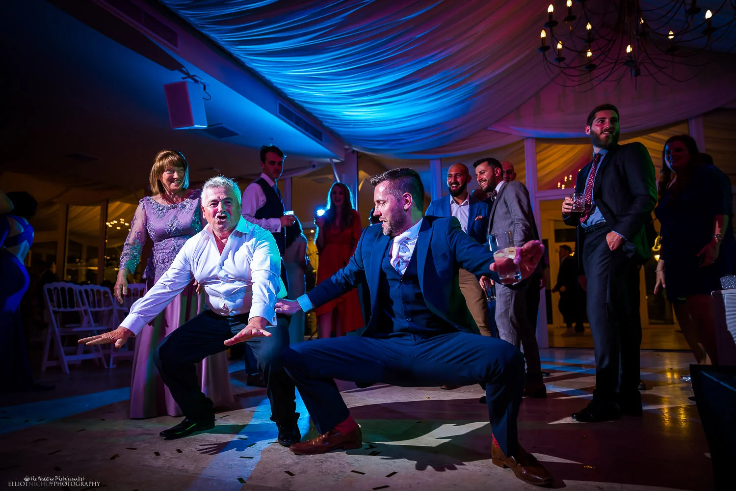 Wedding guests having a dance off during the wedding reception party. Photo by Elliot Nichol Photography.
