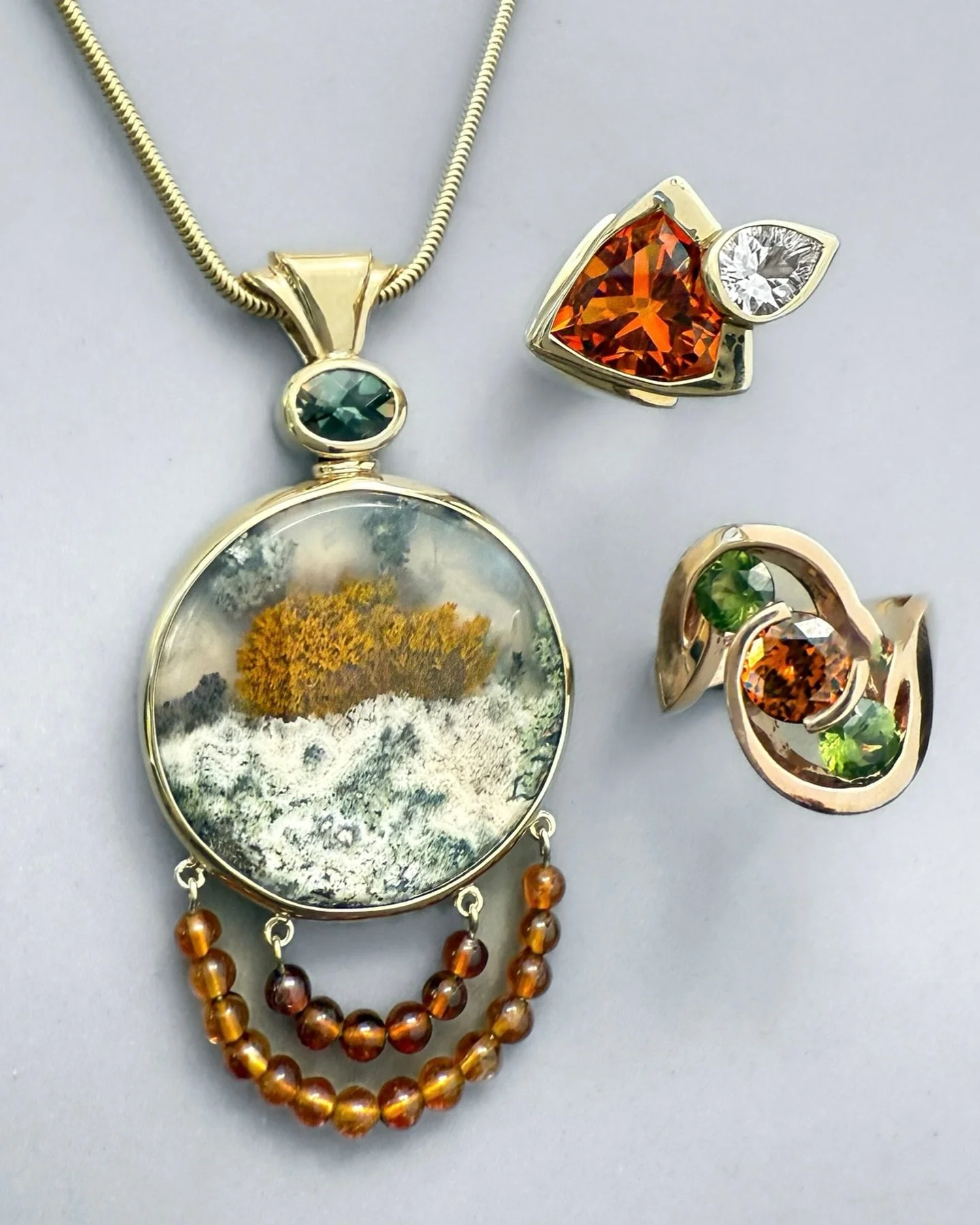 Some natural harvest colors to prep everyone for a wonderful Thanksgiving! Jan Daggett&rsquo;s one of a kind pieces, a gorgeous Indonesian plume pendant with a checkerboard cut green Oregon sunstone and citrine beads, a fiery trillion citrine and whi
