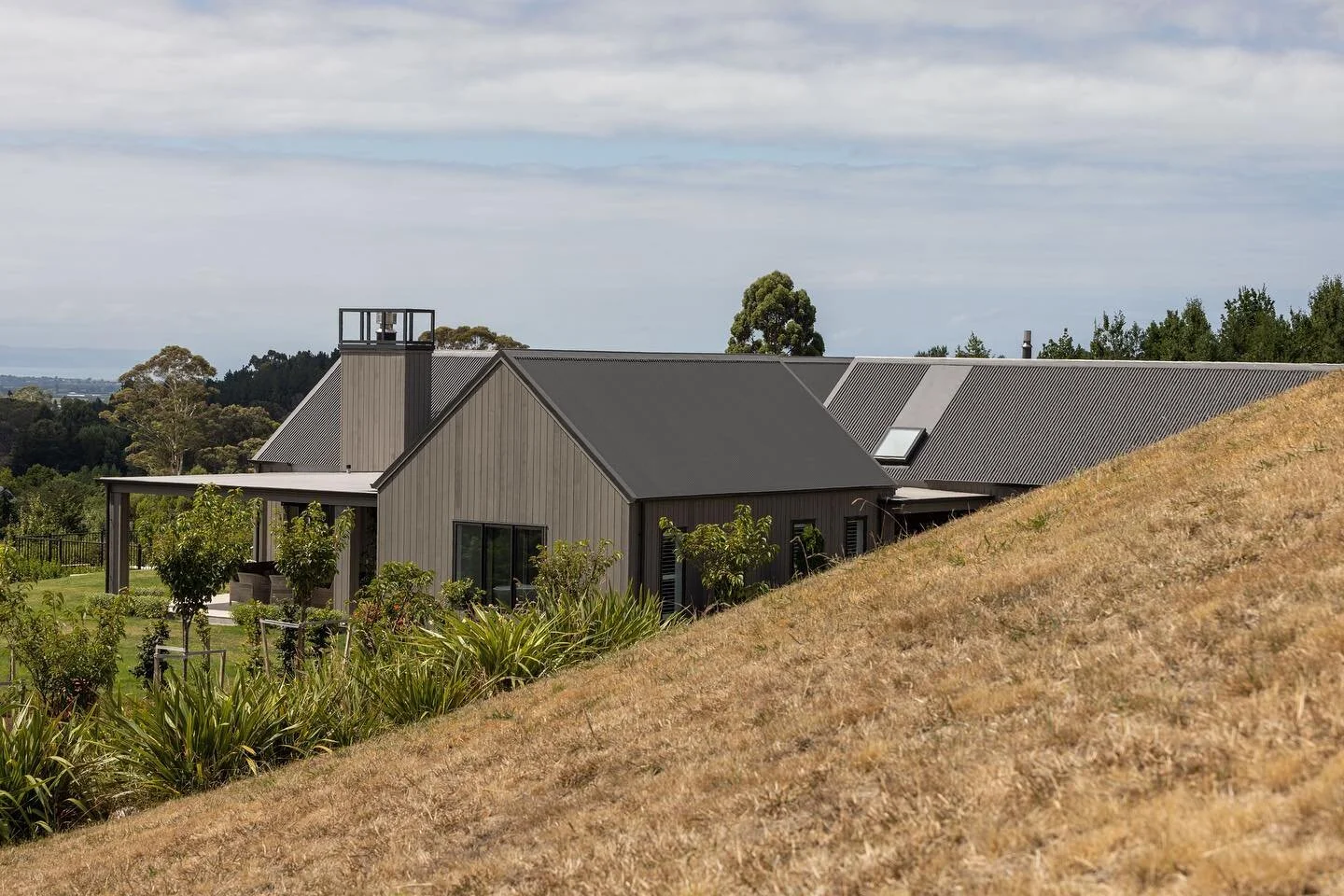 Nelson House, by Clarkson Architects. 

Winner of the Gisborne &amp; Hawkes Bay Architecture Awards 2022. 

Four gabled forms, subtly organised in a pinwheel pattern, create this single storey home, with each distinct but interconnected wing loosely 