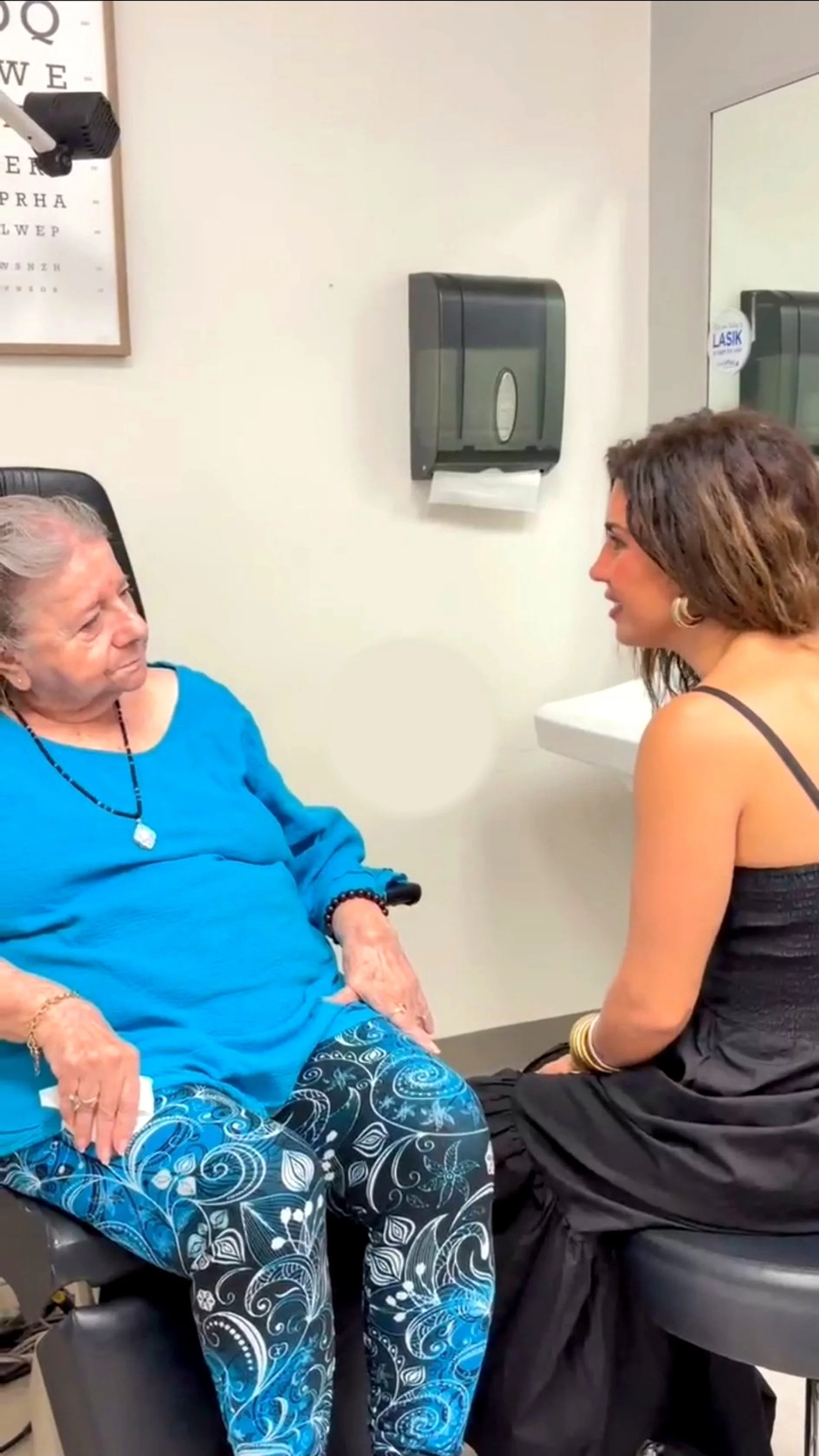 Optometrist talking with a patient in the office