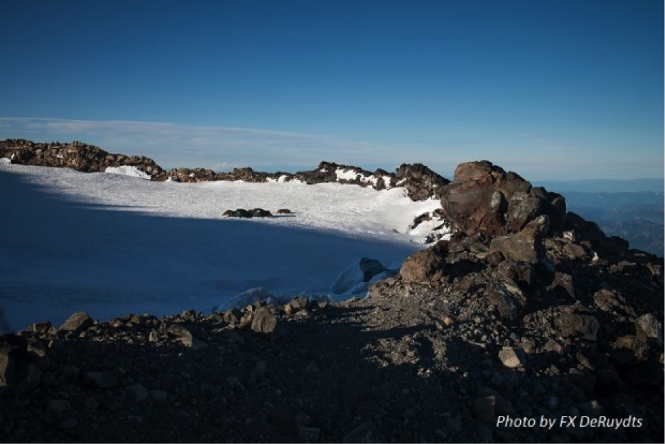 Rainier's East Crater is a 'trapped' ice plug - the crater contains the glacier. This view from near summit shows base camp in the distance.