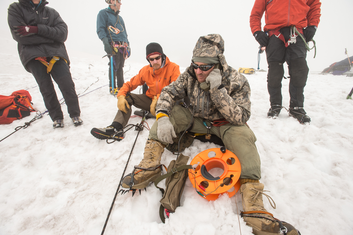 Dr. Woody Peeples talks on cave phone to Eddy, who's in Godzilla Hole below Photo by Eric Guth