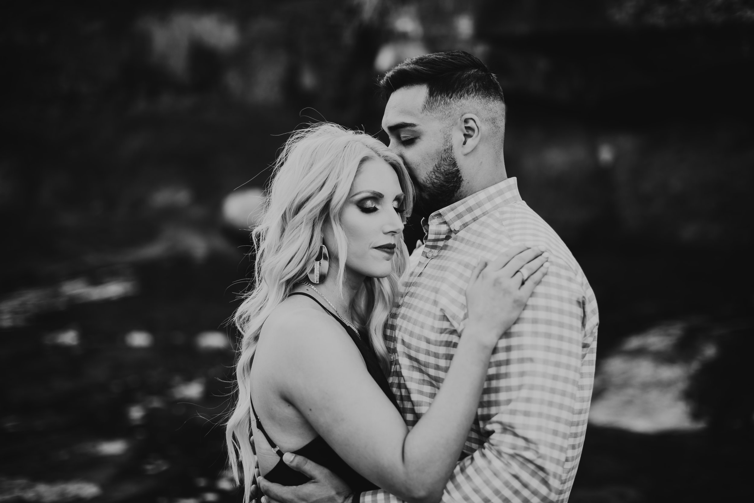 Black and white photo of kiss on the forehead between bride to be and her fiance #engagementphotos #riverfalls #engaged #personality #amarillotexas #engagementphotographer #lifestylephotos #amarillophotographer #locationchoice #texasengagementphotos #engagment #tealawardphotography #wildliferefuge