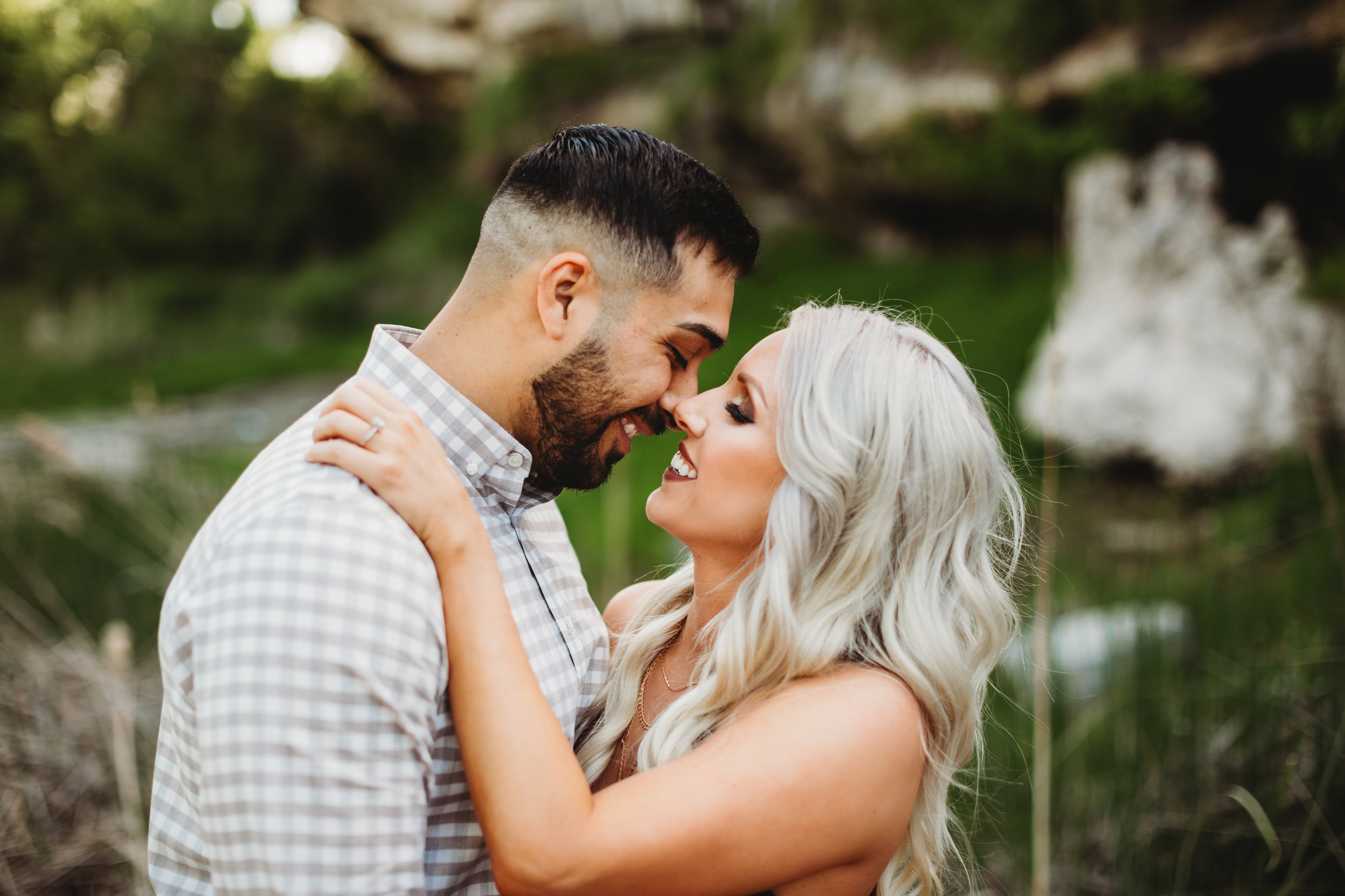 Moments before engaged couple kiss in front of green foliage #engagementphotos #riverfalls #engaged #personality #amarillotexas #engagementphotographer #lifestylephotos #amarillophotographer #locationchoice #texasengagementphotos #engagment #tealawardphotography #wildliferefuge