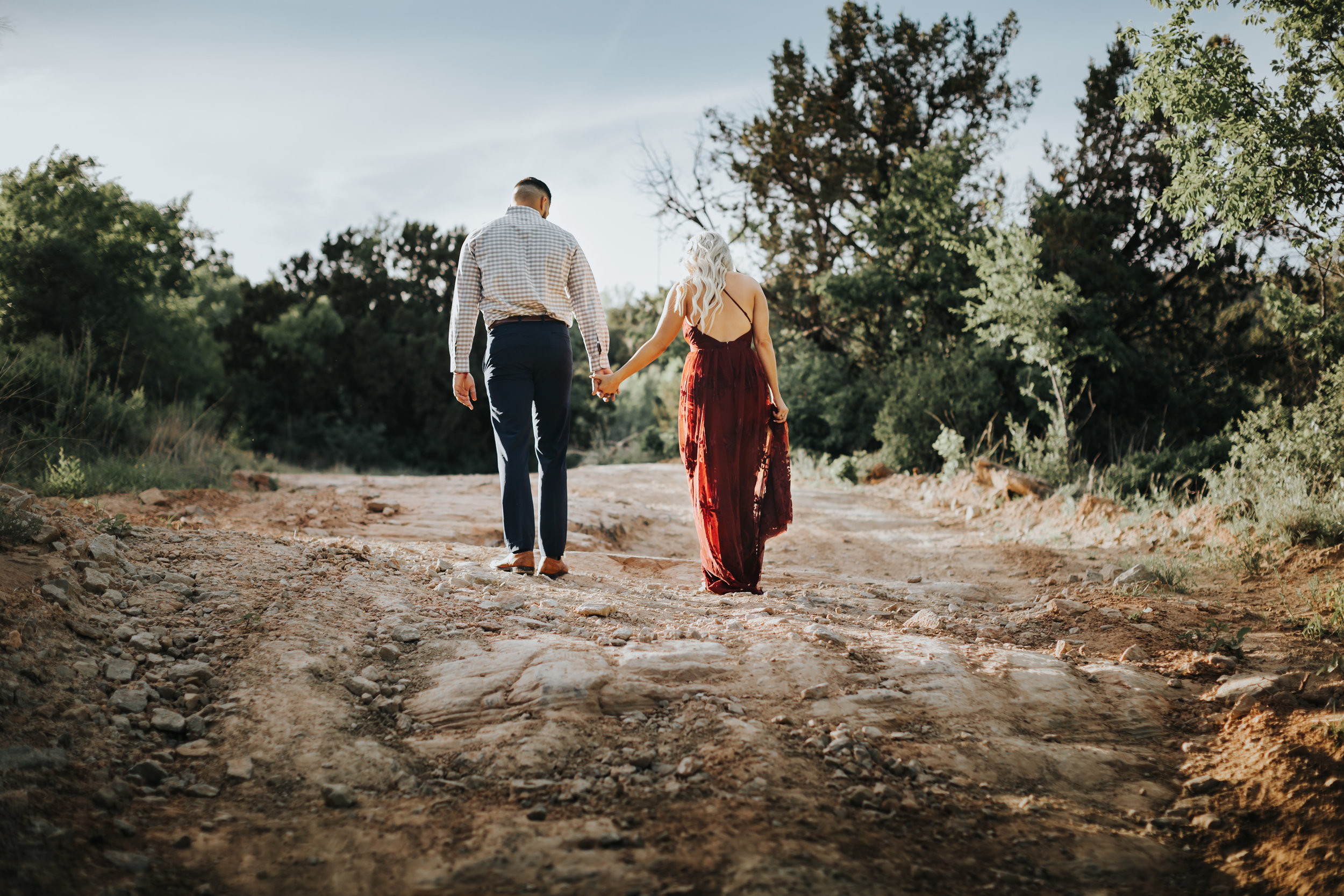 Walking away into the future hand in hand engaged couple walks uphill #engagementphotos #riverfalls #engaged #personality #amarillotexas #engagementphotographer #lifestylephotos #amarillophotographer #locationchoice #texasengagementphotos #engagment #tealawardphotography #wildliferefuge