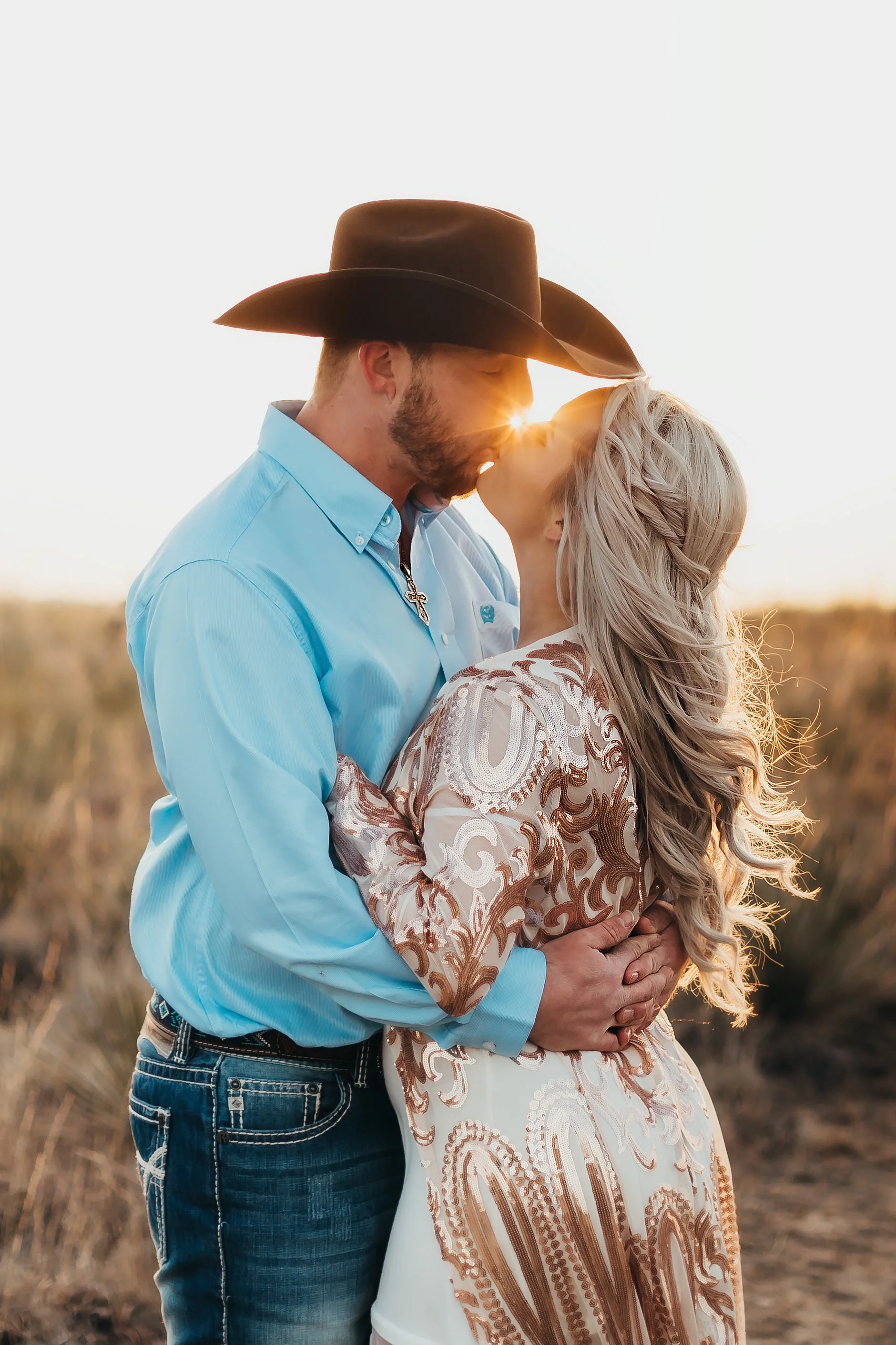Sun set in the middle of an engagement kiss accenting wardrobe choices and cowboy hat #engagementphotos #engaged #personality #amarillotexas #engagementphotographer #lifestylephotos #amarillophotographer #locationchoice #texasengagementphotos #engagment #tealawardphotography #westernstyle