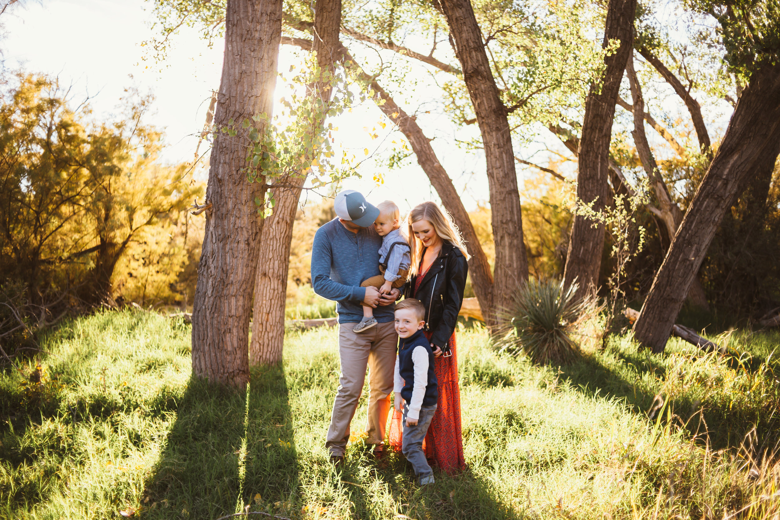 Family of four in front of tall trees and green grass as the sun sets #tealawardphotography #texasfamilyphotographer #amarillophotographer #amarillofamilyphotographer #lifestylephotography #emotionalphotography #familyphotosoot #family #lovingsiblings #purejoy #familyphotos #familyphotographer #greatoutdoors