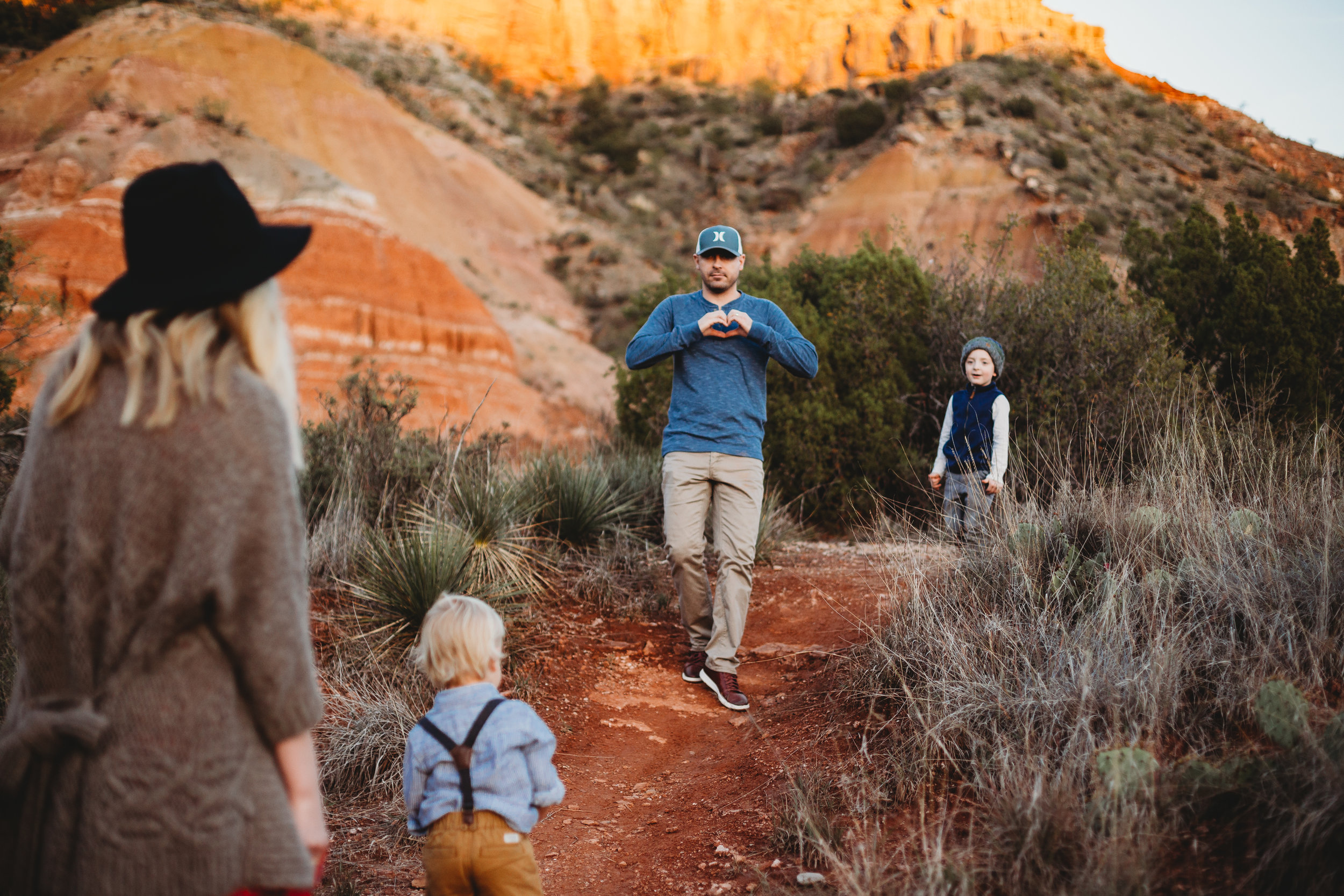 Family walking toward each other with red sandstone in the background #tealawardphotography #texasfamilyphotographer #amarillophotographer #amarillofamilyphotographer #lifestylephotography #emotionalphotography #familyphotosoot #family #lovingsiblings #purejoy #familyphotos #familyphotographer #greatoutdoors