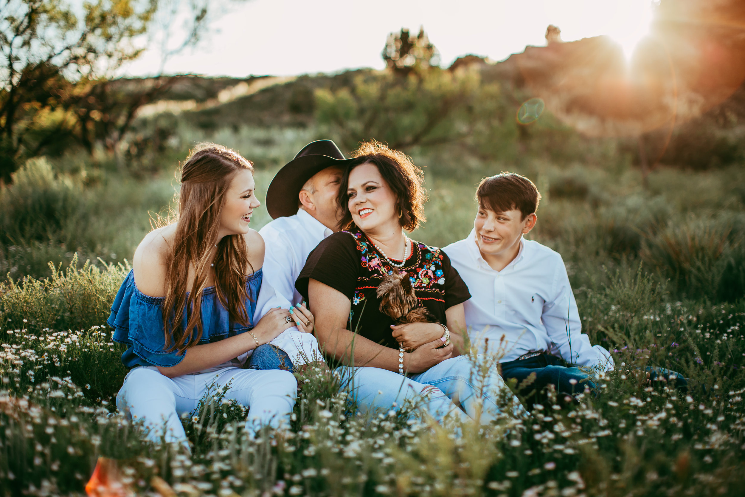 Family sitting together for family photo session on family ranch #tealawardphotography #texaslocationchoice #amarillophotographer #amarillofamilyphotographer #emotionalphotography #engagementphotography #couplesphotography #pickingaphotosessionlocation #whatsimportant #everythingtogether #pickingcolorsforphotos #location #photosessionlocation