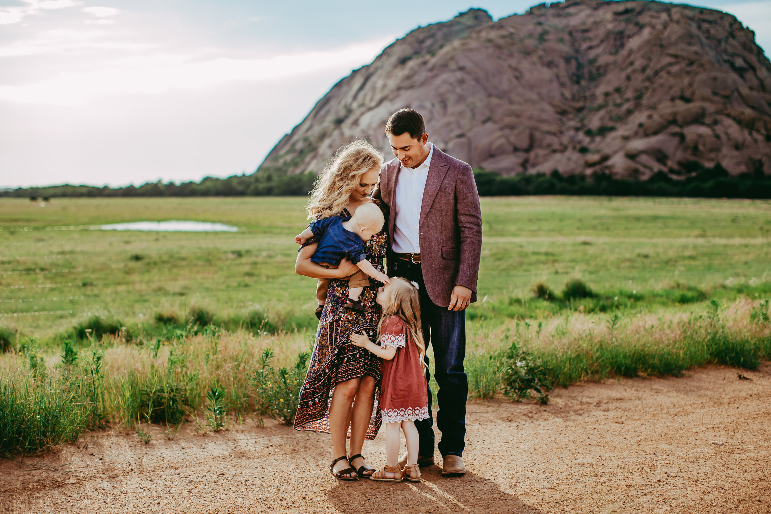 wardrobe color selection with green meadow background and large hill #tealawardphotography #texaslocationchoice #amarillophotographer #amarillofamilyphotographer #emotionalphotography #engagementphotography #couplesphotography #pickingaphotosessionlocation #whatsimportant #everythingtogether #pickingcolorsforphotos #location #photosessionlocation