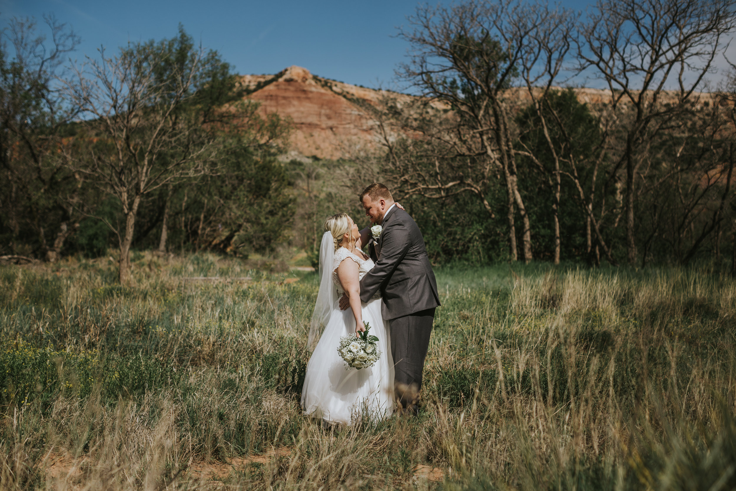  Blue skies against red sandstone rocks this bride and groom share a kiss #tealawardphotography #texasweddings #amarillophotographer #amarilloweddingphotographer #emotionalphotography #intimateweddingphotography #weddingday #weddingphotos #texasphotographer #inspiredwedding #intimatewedding #weddingformals #bigday #portraits 