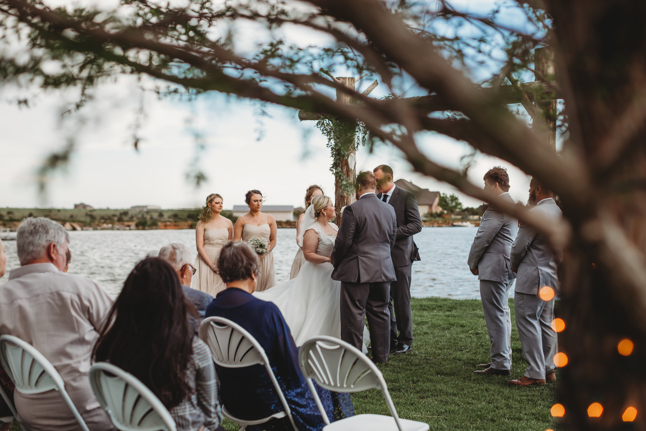  Intimate waterfront wedding ceremony with bridal party and guests #tealawardphotography #texasweddings #amarillophotographer #amarilloweddingphotographer #emotionalphotography #intimateweddingphotography #weddingday #weddingphotos #texasphotographer #inspiredwedding #intimatewedding #weddingformals #bigday #portraits 