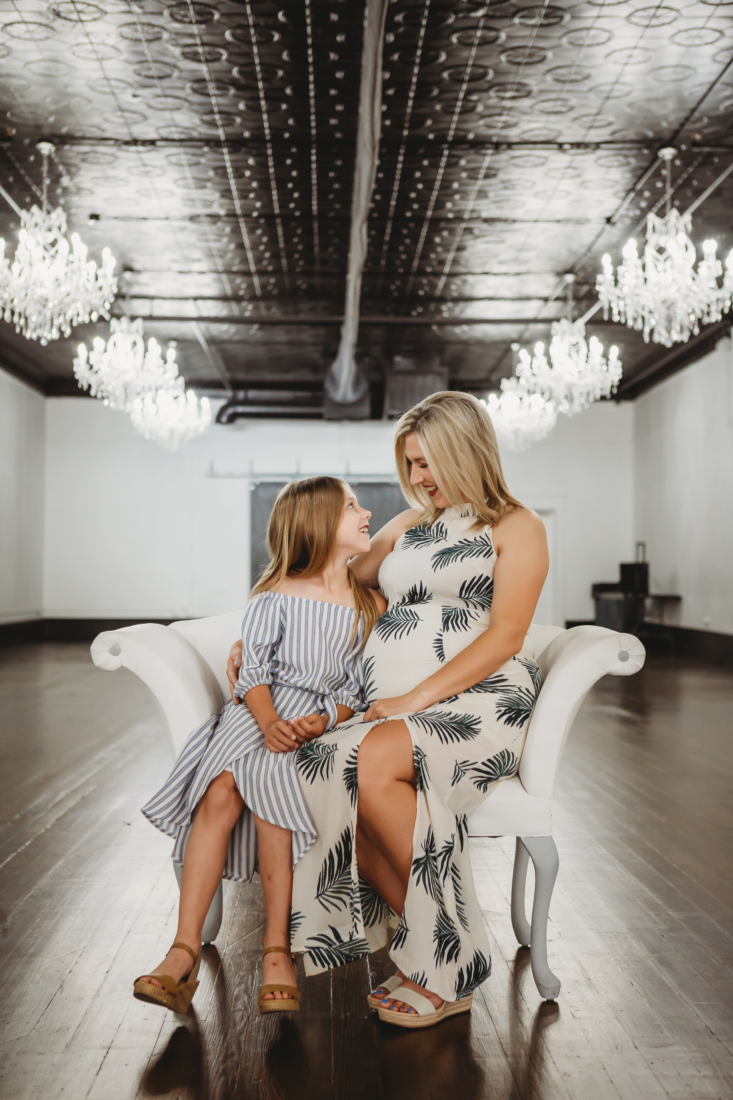  Mother and daughter side by side in room lined with chandeliers #tealawardphotography #texasmaternityphotographysession #amarillophotographer #amarilloematernityphotographer #emotionalphotography #lifestylephotography #babyontheway #lifestyles #expectingmom #newaddition #sweetbaby #motherhoodmagic 