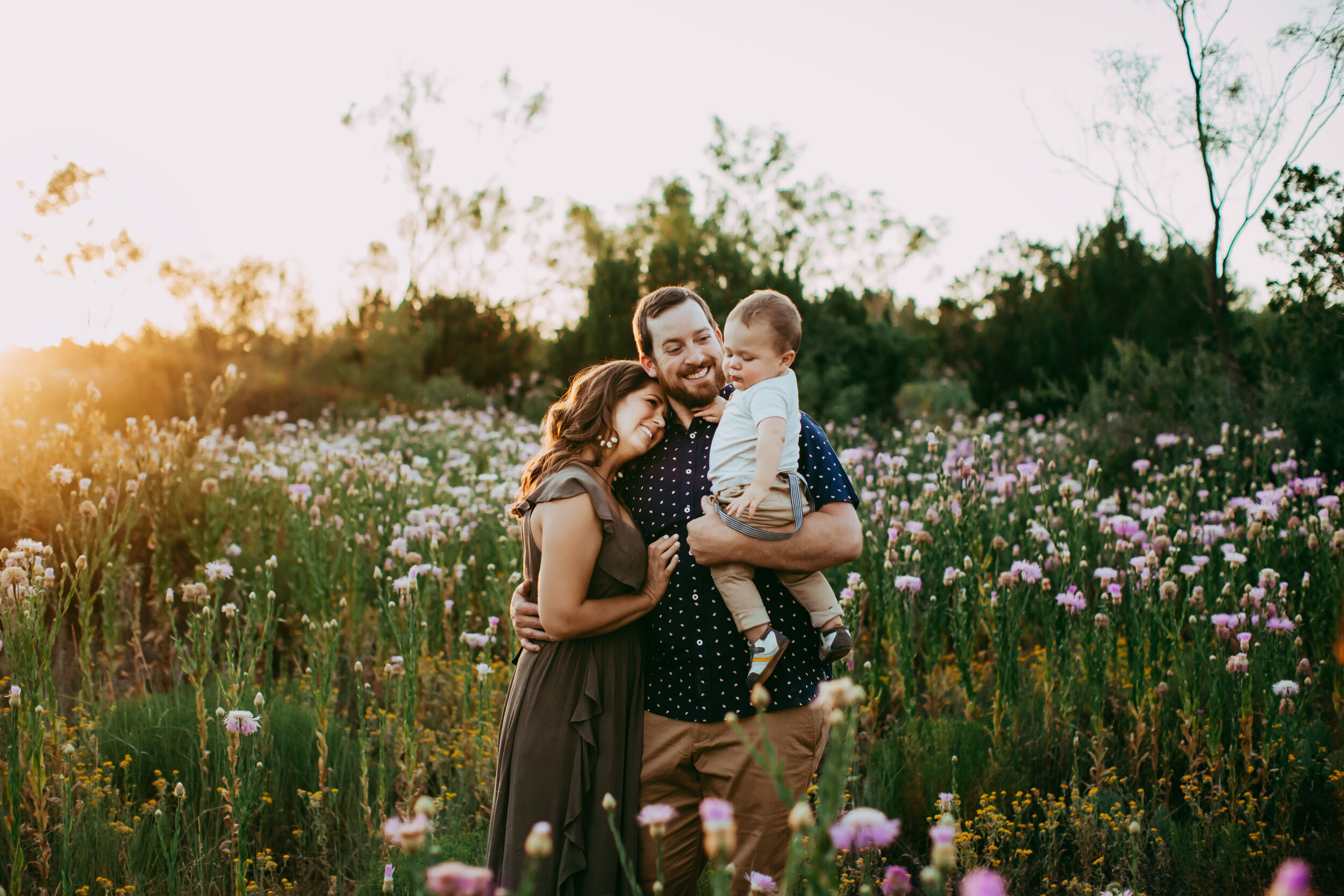 Tender hug between this family of three in the middle of this wildflower field at sunset #tealawardphotography #texasfamilyphotographer #amarillophotographer #amarillofamilyphotographer #lifestylephotography #emotionalphotography #familyphotoshoot #family #lovingsiblings #purejoy #familyphotos #naturalfamilyinteraction