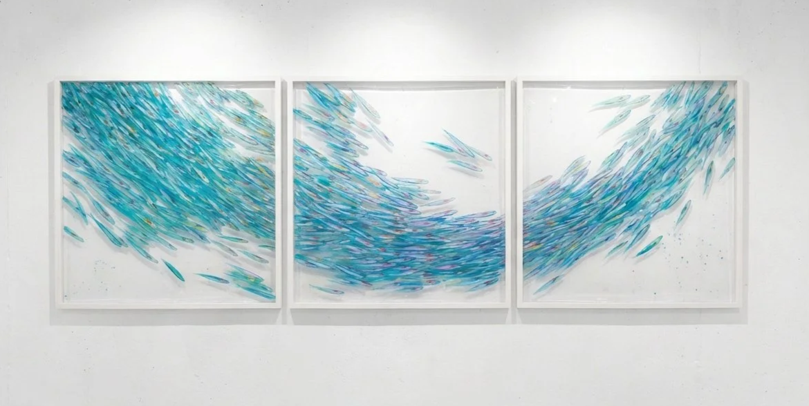 Triptych artwork featuring a shimmering shoal of blue and rainbow fish on a white background
