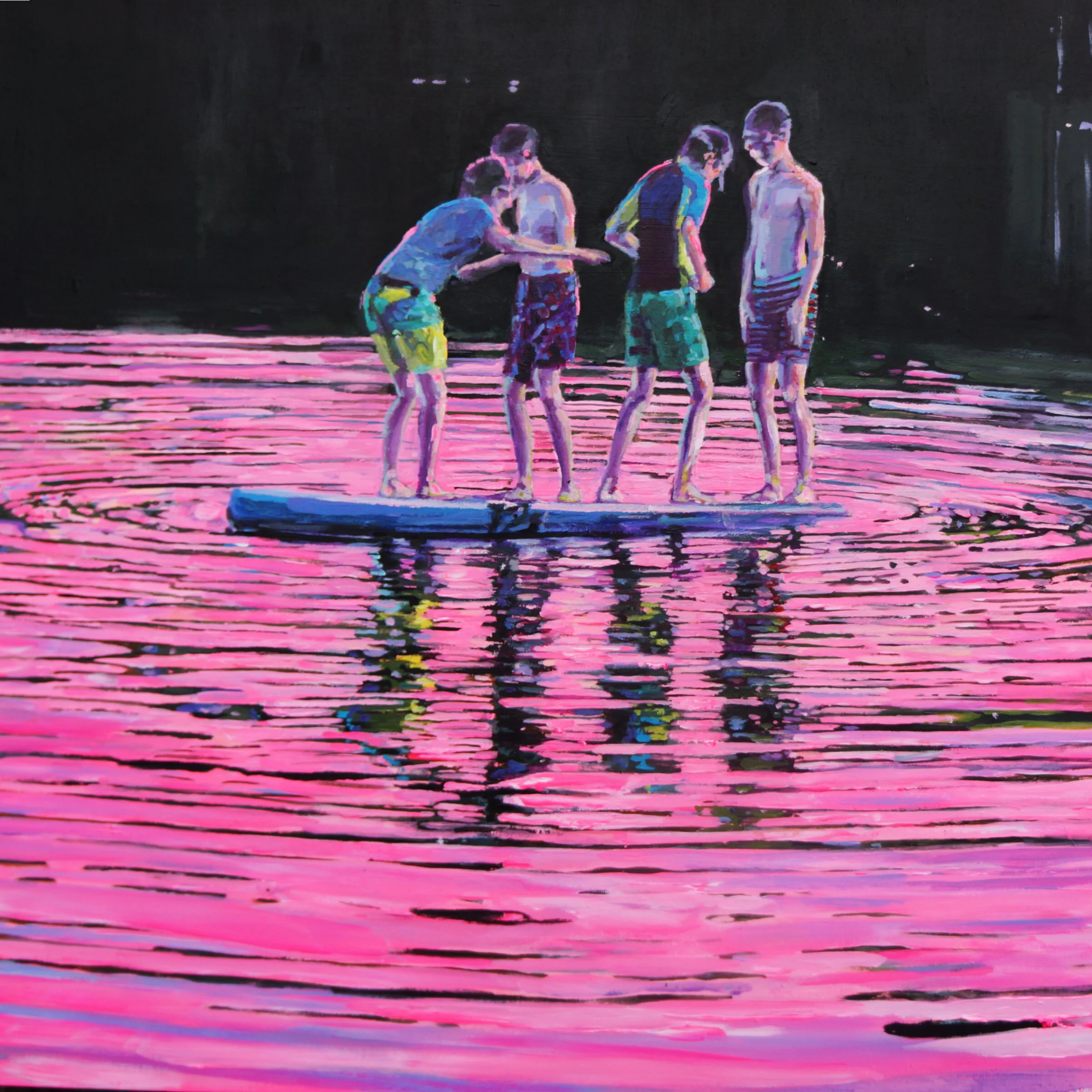 Four people standing on a paddleboard on pink-colored water, with their reflections visible.