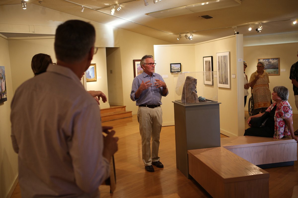 John Robinson, curator, explains setting up the display in the Kings County Art Center.