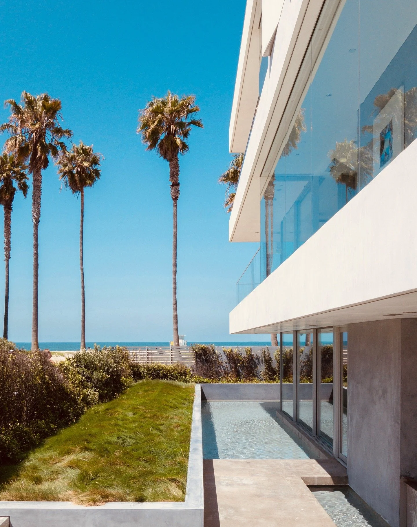 We recently took a studio tour of Flip Flop House to see how our first ever beach fronting house is doing more than a decade since completion. Entering the house, you walk over a mini bridge over a &quot;moat&quot; that encompasses the house. We set 