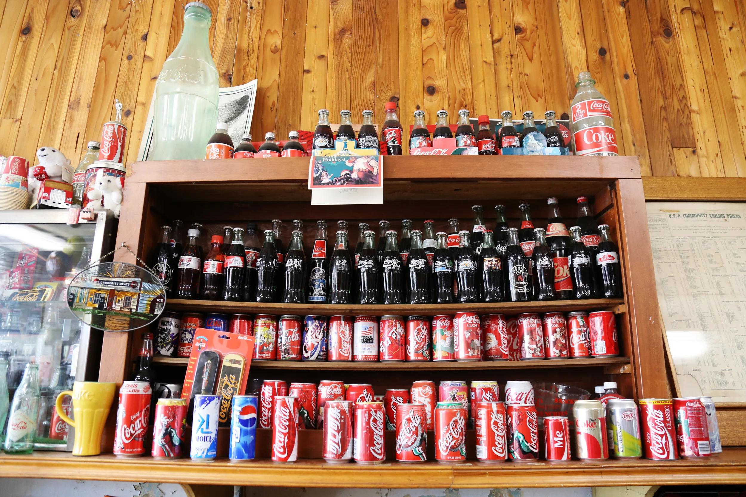The soda shop boasts an impressive display of Coke bottles from years past.
