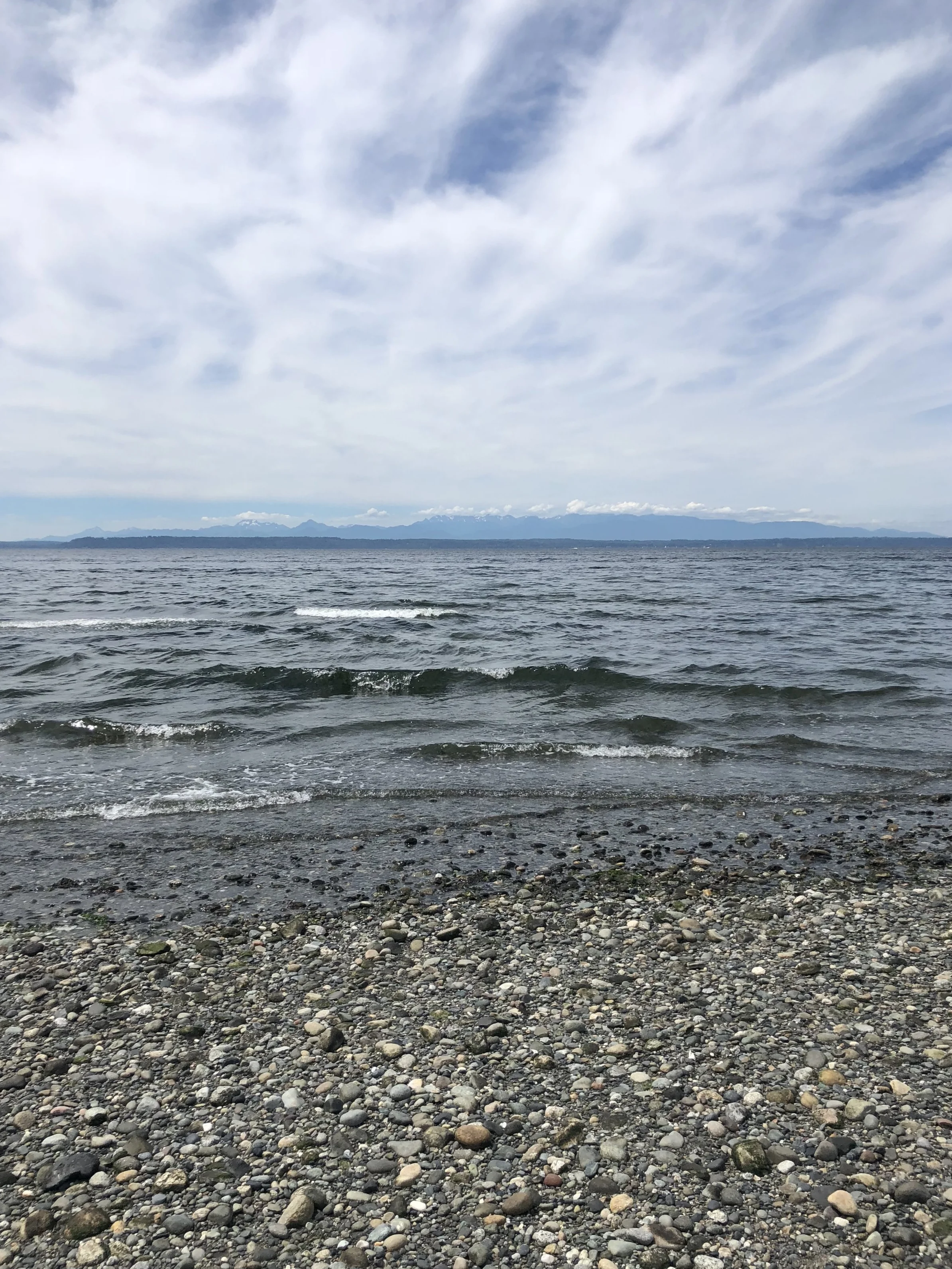 Enjoying the sounds of the ocean and taking in the views of the Olympic Mountains from the beach at the end of the hike.