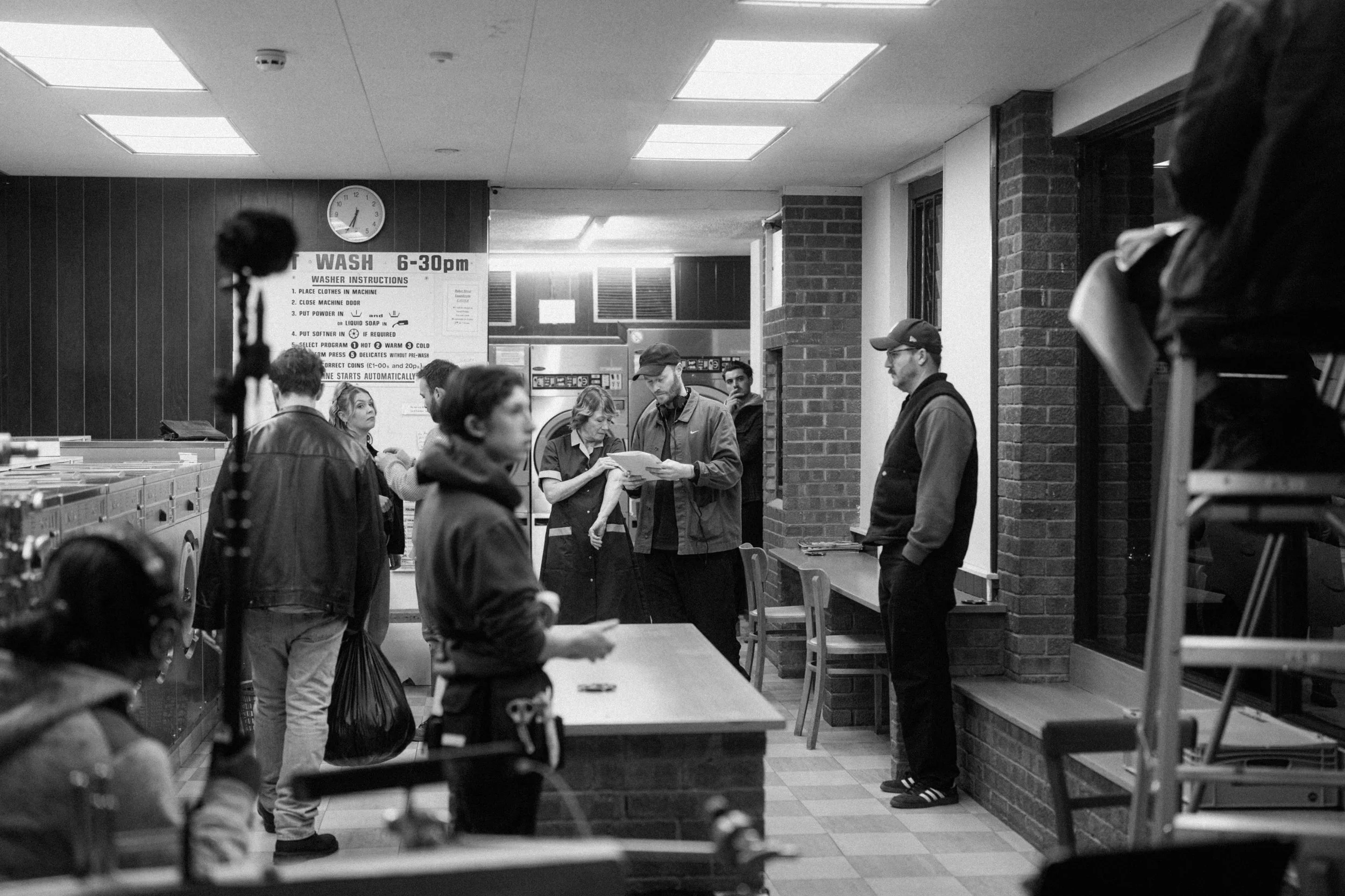 Director reads script with cast in between takes