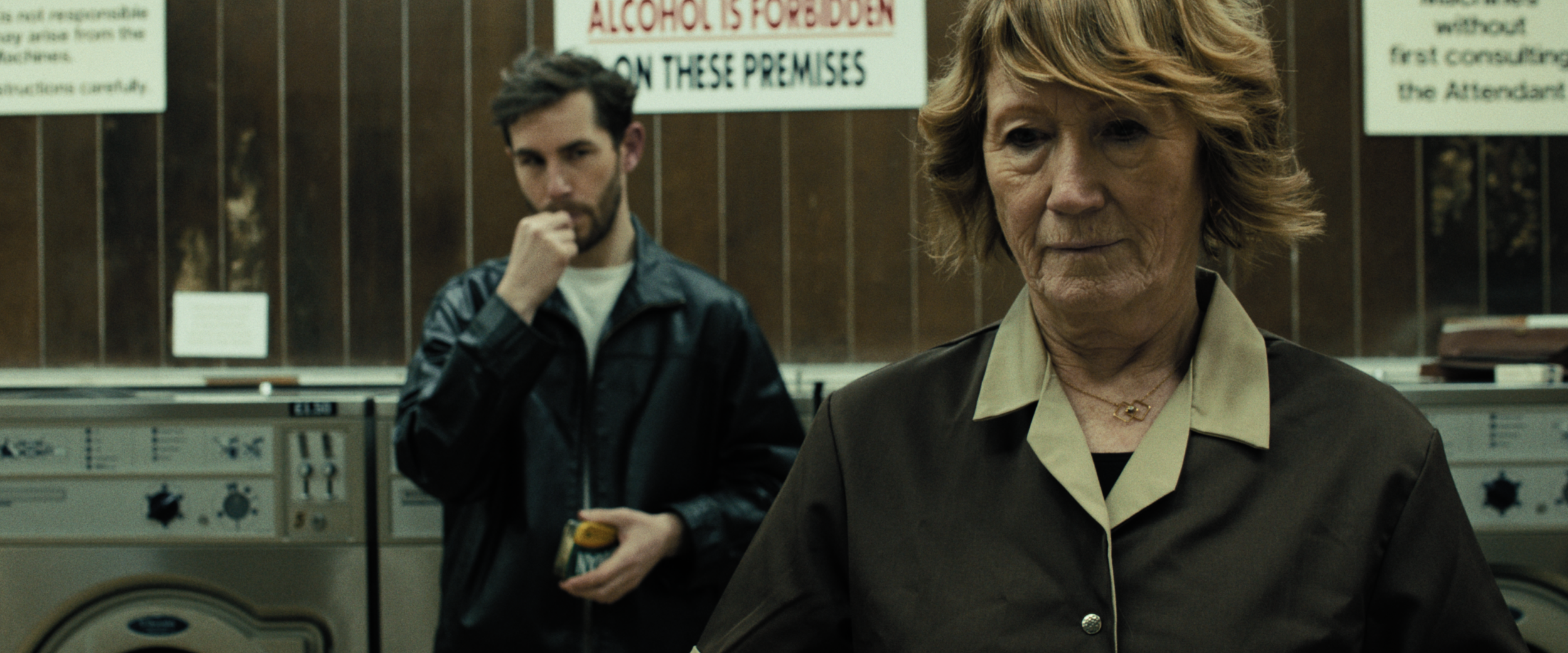 Woman in launderette senses man looking at her