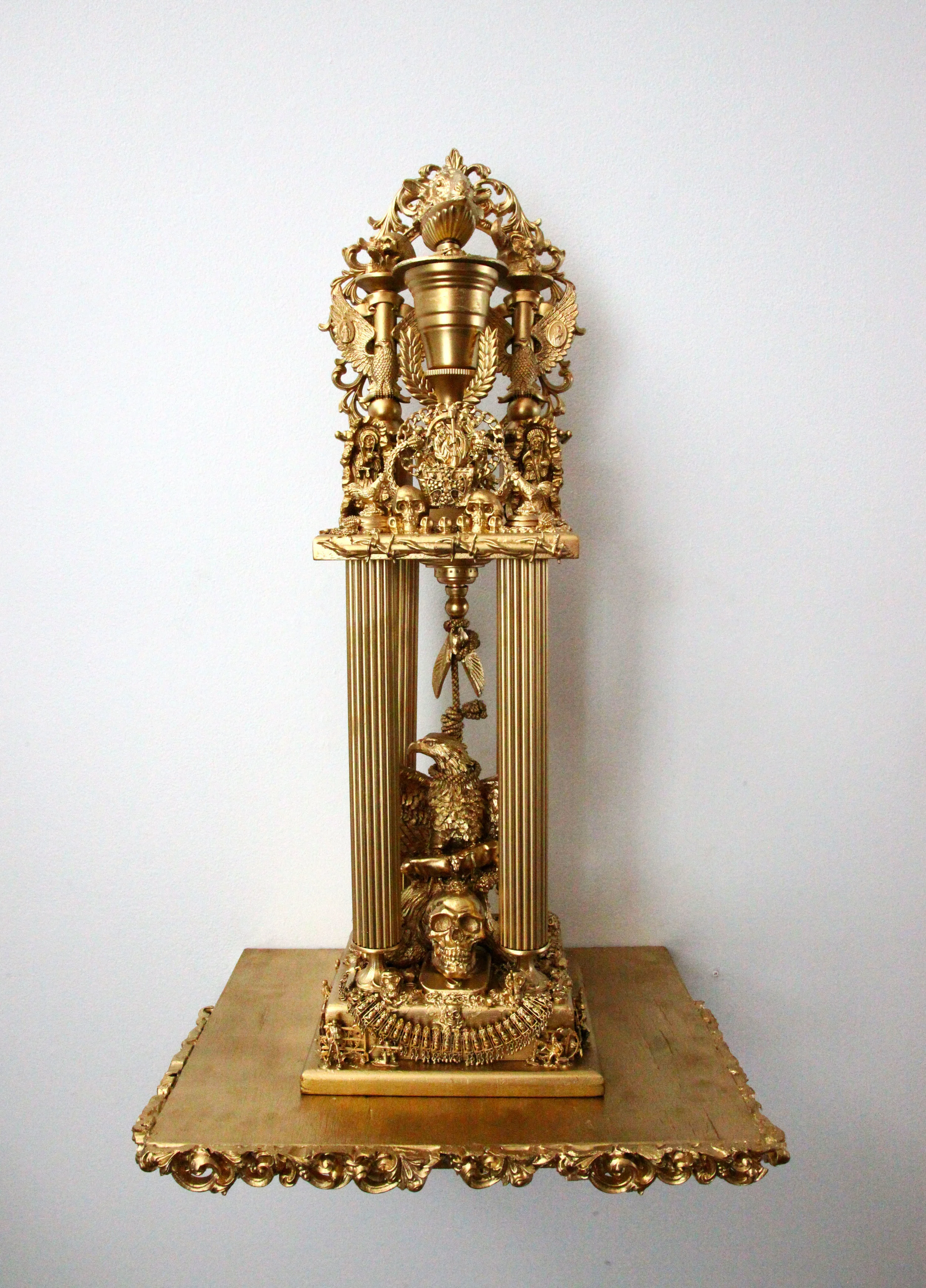 "Trophy #1 -- Trophy of the History of Greed, Terror, and our Participation" Mixed media, found objects 29" x 10" w/o shelf, 39" x 24" w/shelf 2016