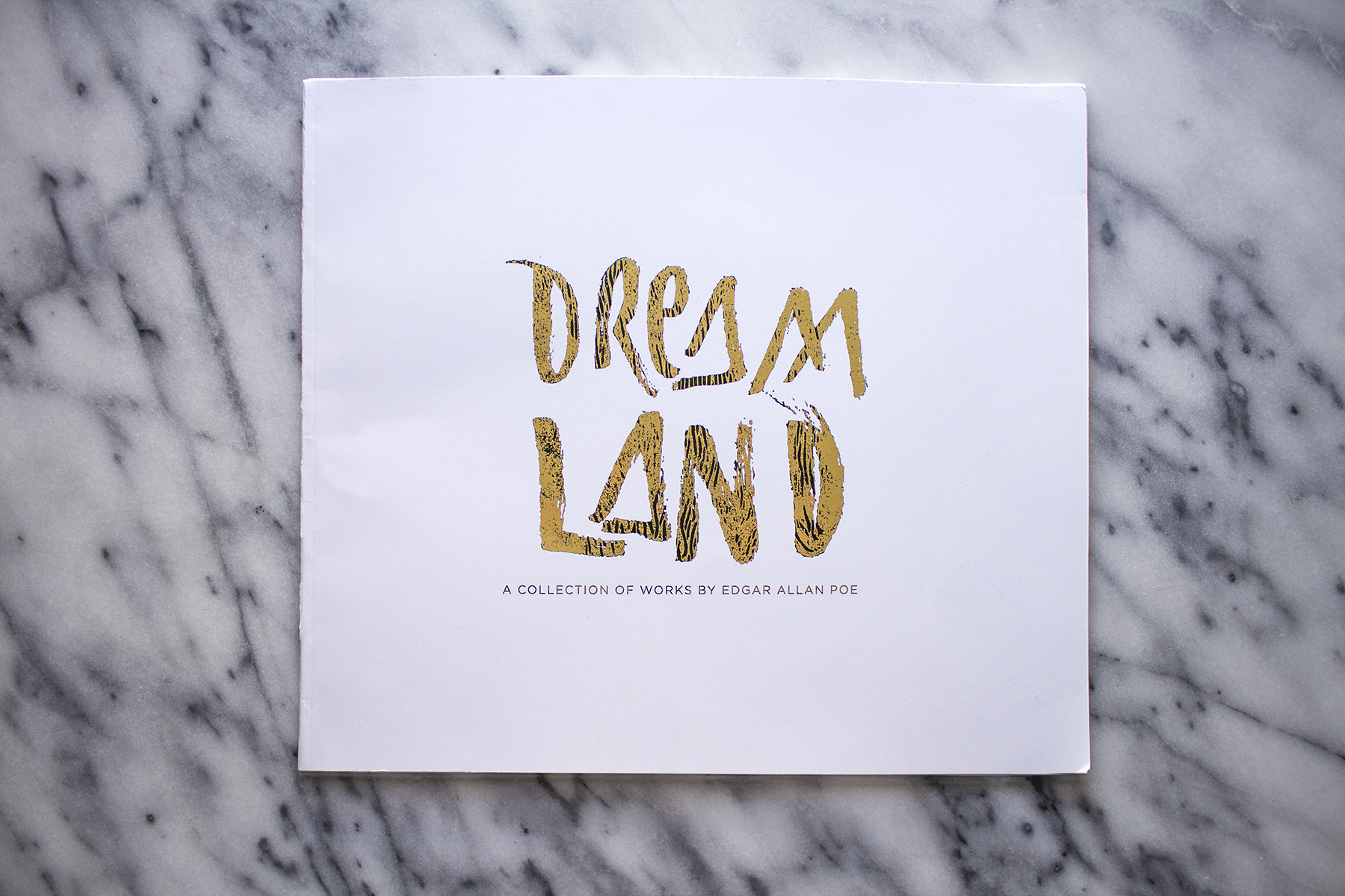Dreamland is a coffee table book which features a compilation of classic poetry by Edgar Allan Poe as well as original photography. The photos were manipulated to mimic the same haunting mood captured in Poe’s poetry. The book also features distressed hand lettering throughout as well as gold foil accents.
