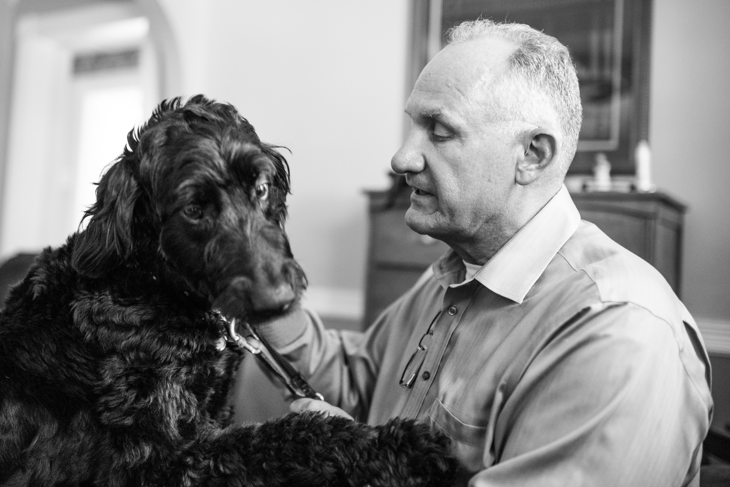 Jim with his service dog, a Labradoodle named Sophie.