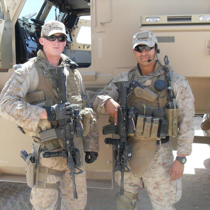 Evan stands (left) with his team leader Corporal Roberto Martinez during in his time in Iraq. 