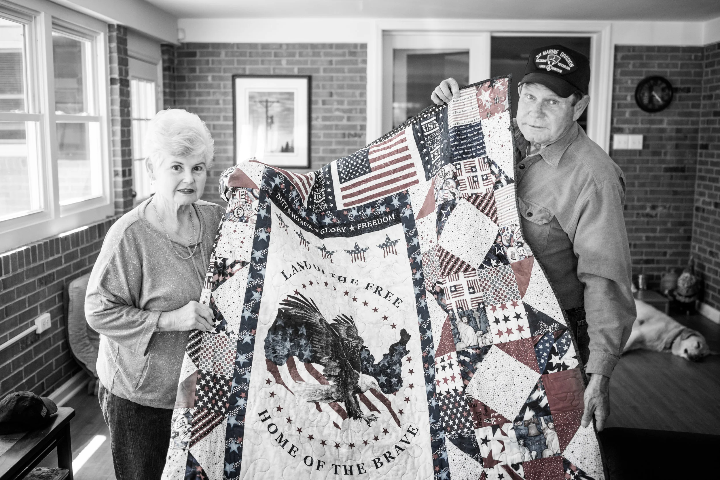 Bobby and his wife hold up his "Quilt of Valor." 